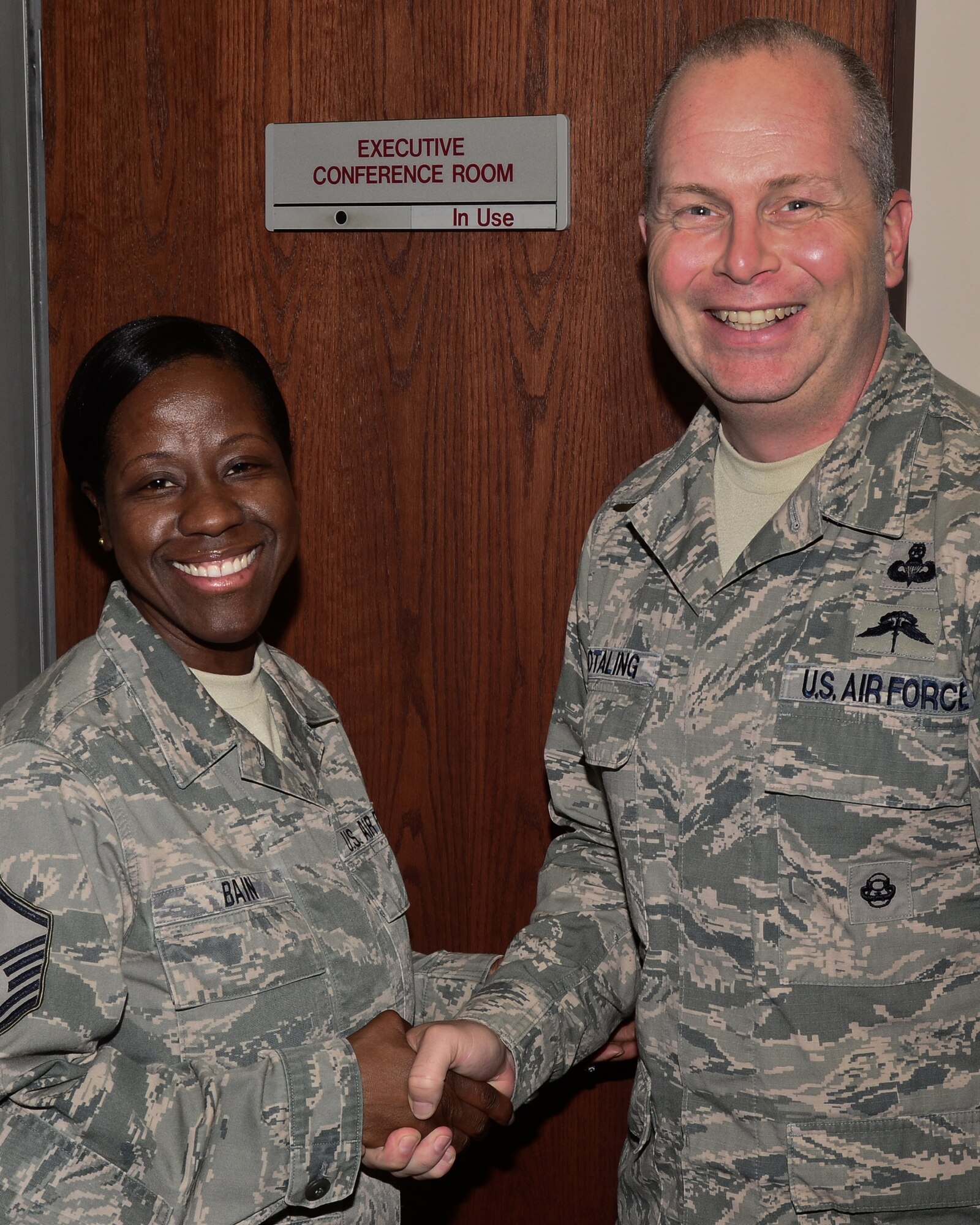 Master Sgt. Chena Bain, 166th Airlift Wing, Delaware Air National Guard is coined by ANG Command Chief Master Sgt. James Hotaling during a visit to the New Castle ANG Base, Delaware on Oct. 18, 2014 (U.S. Air National Guard photo by Staff Sgt. Andrew Horgan)