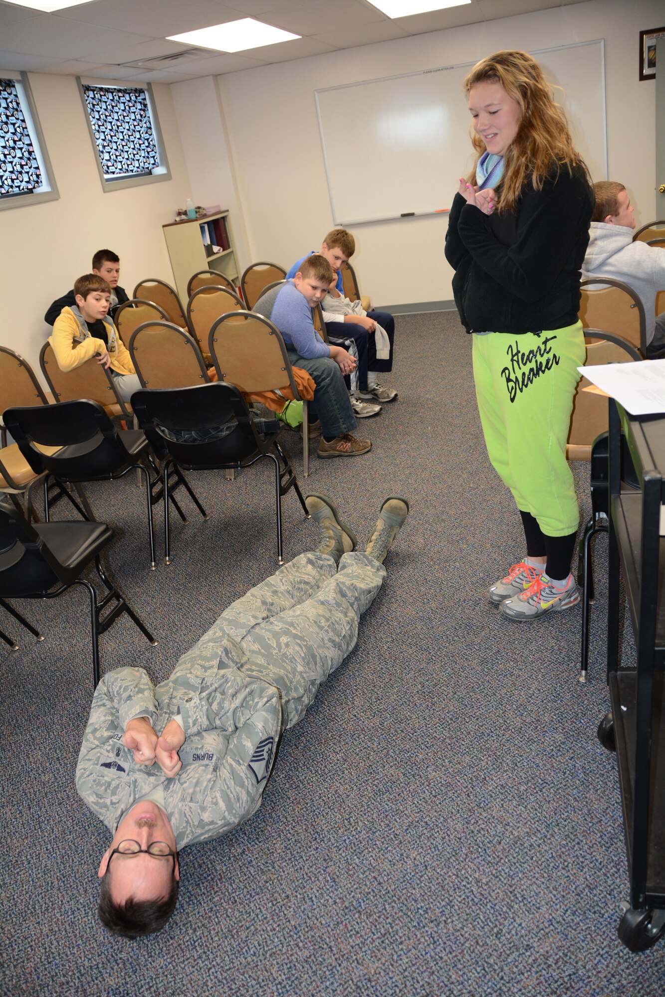 Master Sgt. Robert Burns, 512th Aerospace Medicine Squadron, demonstrates for Delaware Civil Air Patrol cadet Brianna Boyd, how to play a victim who has had serious head trauma during a training exercise Nov. 2, 2014, at Dover Air Force Base, Del. To assist the 512th AMDS in the training exercise, she and several other cadets were dressed with prosthetics and fake blood that simulated various injuries, including punctured eyes, open bone fractures and lacerations. (U.S. Air Force photo/Senior Airman Joe Yanik)  