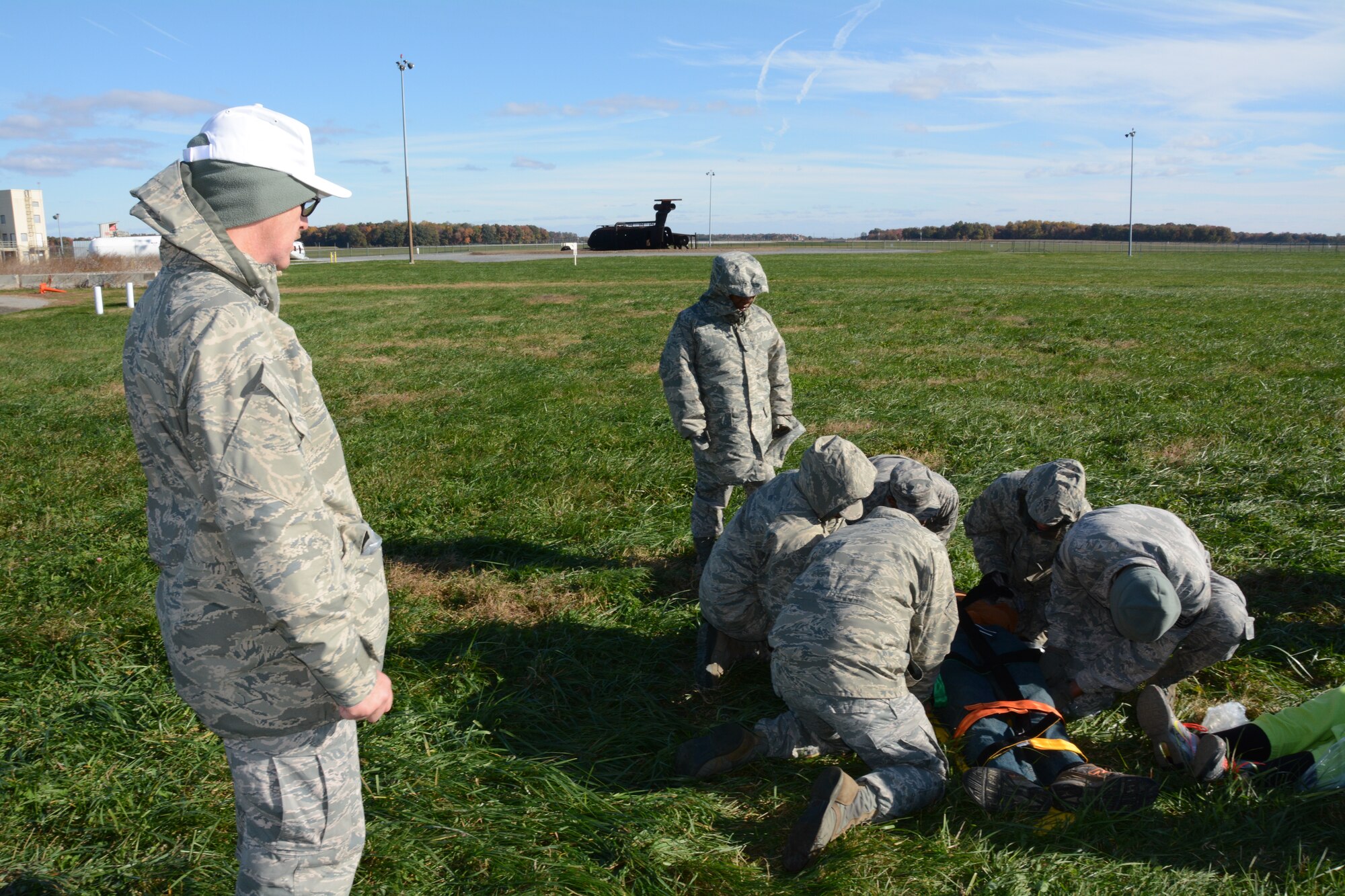 Master Sgt. Robert Burns, 512th Aerospace Medicine Squadron exercise evaluation team leader, observes other medical reservists as they simulate first response assessments of a Delaware Civil Air Patro cadet Nov. 2, 2014, at Dover Air Force Base, Del. The training served to prepare participants for real world mass casualty emergencies. (U.S. Air Force photo/Senior Airman Joe Yanik)  