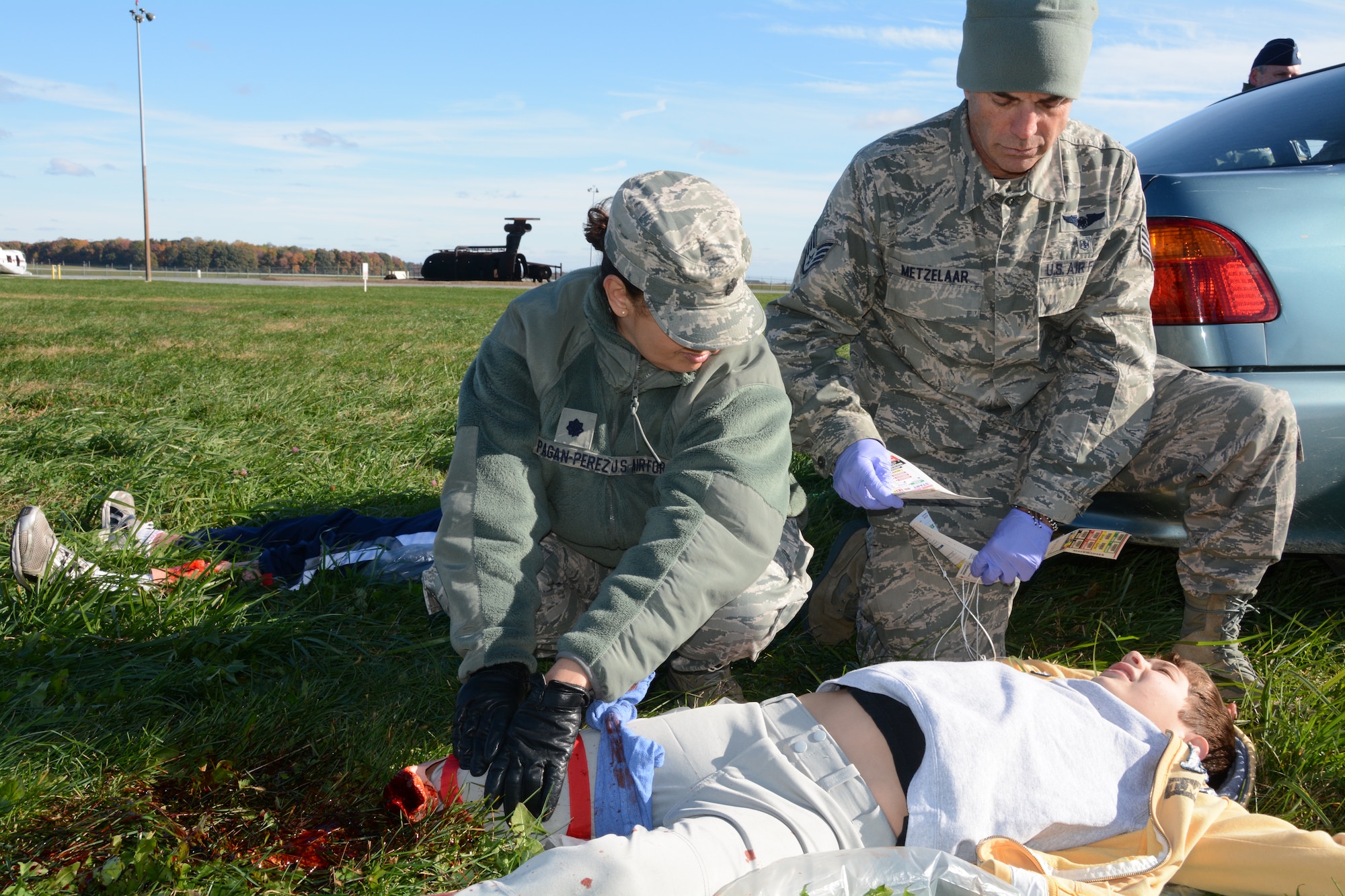 Lt. Col. Mildred Pagan-Perez (left) and Staff Sgt. Mark Metzelaar, 512th Aerospace Medicine Squadron, simulate first response treatment of Delaware Civil Air Patrol cadet Sam Rundle during a training exercise Nov. 2, 2014, at Dover Air Force Base, Del. Rundle and other CAP cadets played the roles of victims to assist the 512th AMDS prepare for real world mass casualty emergencies. (U.S. Air Force photo/Senior Airman Joe Yanik)  
