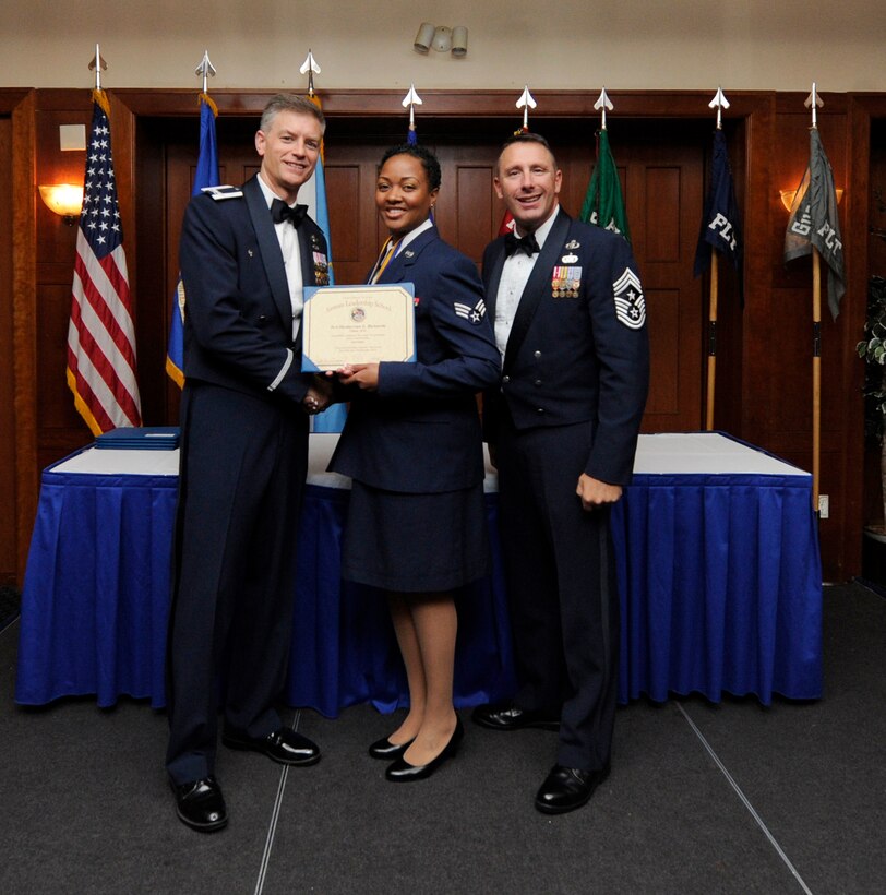 Airman Leadership School (ALS) is a five-week professional military education course which serves as the educational bedrock for new noncommissioned officers. Col. Daniel Waters, 11th Wing Vice Commander and Chief Master Sgt. Vance Kondon, 11th Wing Command Chief present Sr. Airman Shyderrian Richards, from 779th Medical Group Medical Operations Squadron, with her ALS Graduation Certificate.   (AF File Photo)