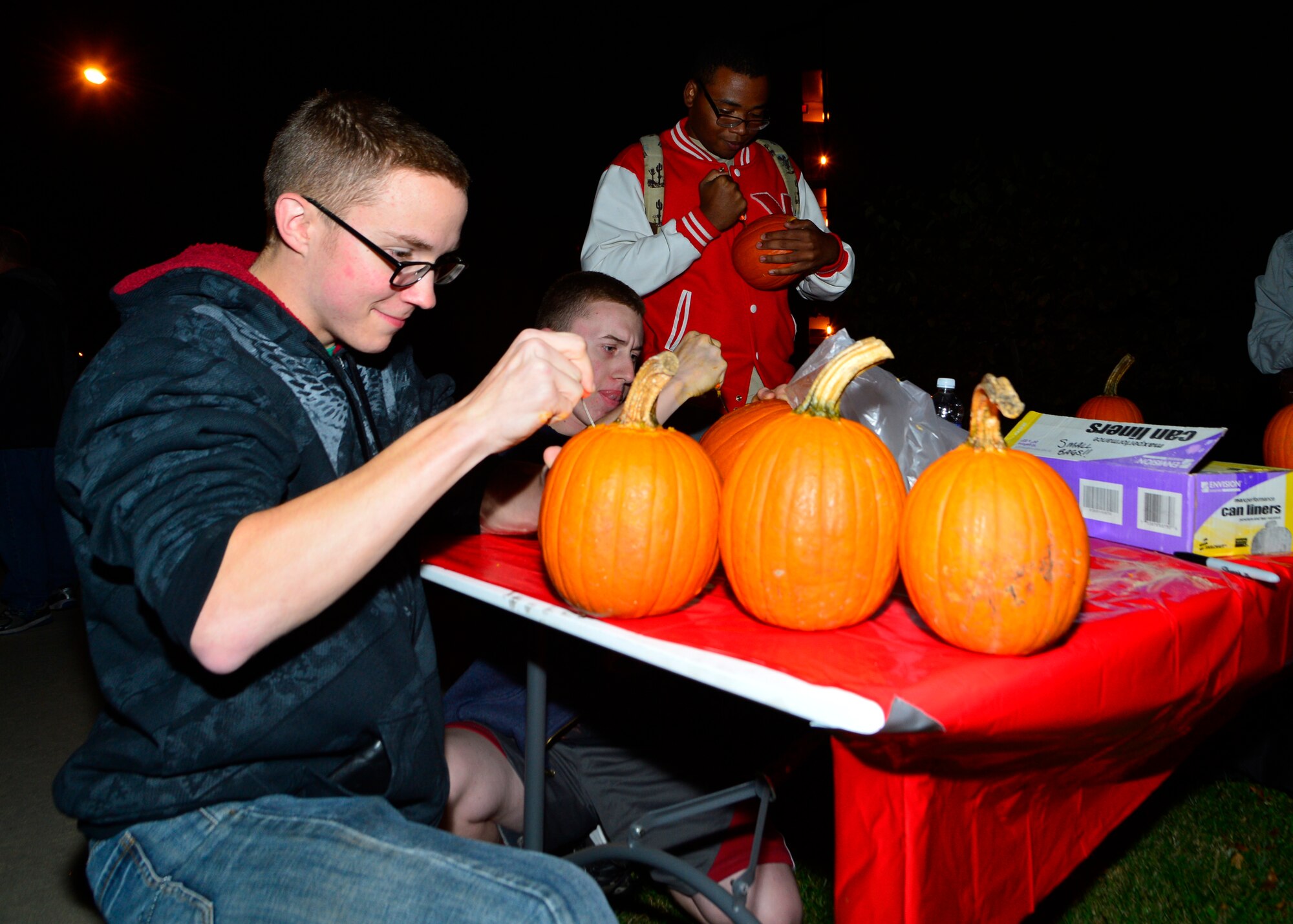 Airman 1st Class Kyle Ferry, 436th Operations Support Squadron air traffic controller apprentice, carves a pumpkin during a combined dinner and “Trunk-or-Treat” event sponsored by the Chief’s Group and Airmen Dorm Council Oct. 30, 2014, at Dover Air Force Base, Del. Free pumpkins were provided for Airmen and Team Dover families to carve during the Halloween event and a gift card was given for the best carved pumpkin. (U.S. Air Force photo/Airman 1st Class William Johnson)