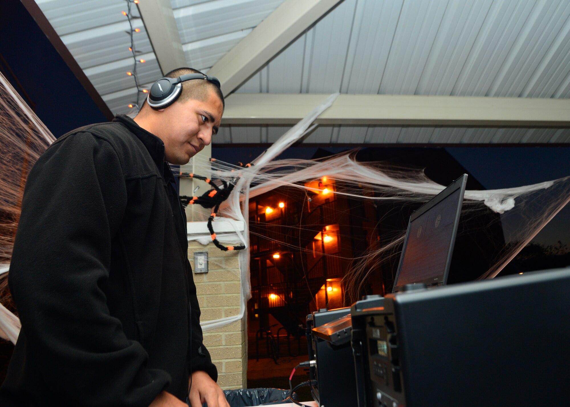Airman 1st Class Jose Garcia, 436th Force Support Squadron personnelist, provides music and entertainment during a combined dinner and “Trunk-or-Treat” event sponsored by the Chief’s Group and Airmen Dorm Council Oct. 30, 2014, at Dover Air Force Base, Del. The event featured grilled hotdogs and hamburgers and a free raffle was held for gift cards and a 32-inch TV. (U.S. Air Force photo/Airman 1st Class William Johnson)