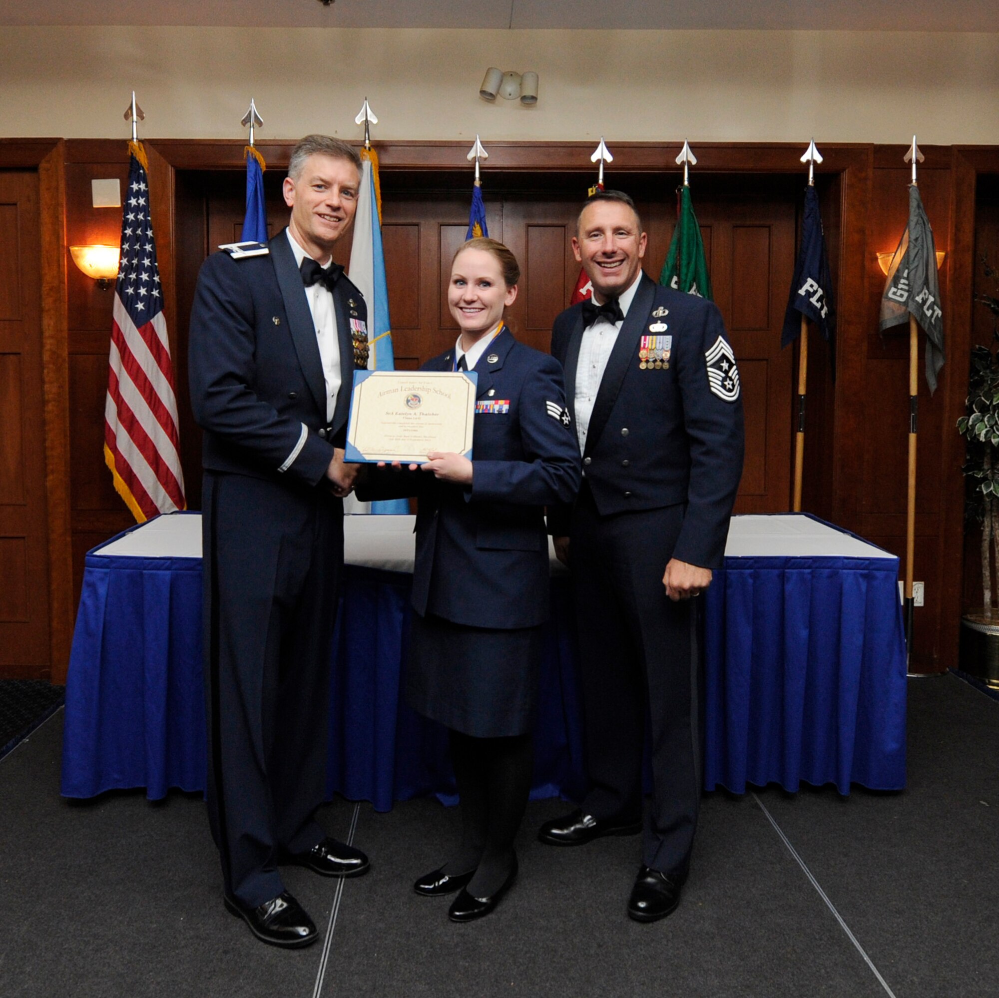 Airman Leadership School (ALS) is a five-week professional military education course which serves as the educational bedrock for new noncommissioned officers. Col. Daniel Waters, 11th Wing Vice Commander  and Chief Master Sgt. Vance Kondon, 11th Wing Command Chief present Sr. Airman Katelyn Thatcher, from 779th Medical Group Medical Operations Squadron, with her ALS Graduation Certificate. (AF File Photo)