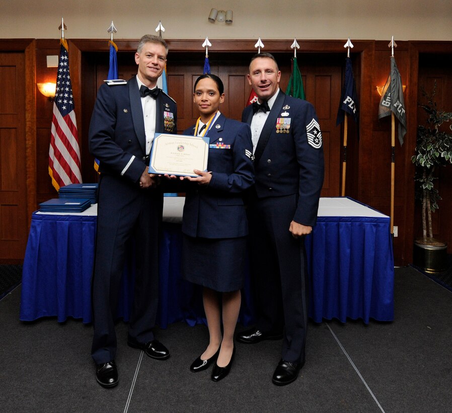 Airman Leadership School (ALS) is a five-week professional military education course which serves as the educational bedrock for new noncommissioned officers.  Col. Daniel Waters, 11th Wing Vice Commander and Chief Master Sgt. Vance Kondon, 11th Wing Command Chief present Sr. Airman Erica Elliott, from 779th Medical Group Medical Operations Squadron, with her ALS Graduation Certificate. (AF File Photo)