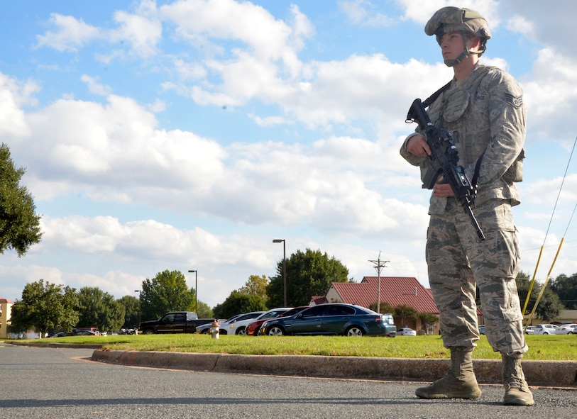 Staff Sgt. Jacob Symmonds, 2nd Security Forces Squadron installation patrolman, guards a simulated cordon during an active shooter exercise on Barksdale Air Force Base, La., Oct. 26, 2014. If the threat of an improvised explosive device is present, law enforcement agencies will set up a cordon to keep personnel and traffic away from the blast area. (U.S. Air Force photo/Airman 1st Class Mozer O. Da Cunha)