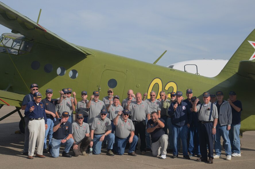 An aircraft restoration crew, comprised mainly of volunteers, poses for a group photo to recognize the completed restoration of a Soviet-era Antonov AN-2 aircraft Oct. 28, 2014, at the Air Mobility Command Museum on Dover Air Force Base, Del. This Antonov AN-2, now on display, is the first foreign airlifter to be displayed at the AMC Museum. This aircraft, along with a dozen others, will be opened for visitors to enter the flight deck and cargo bay on Saturday, Nov. 15, 2014, for the last open aircraft day of the year. (Courtesy photo/Larry Koewing, AMC Museum)