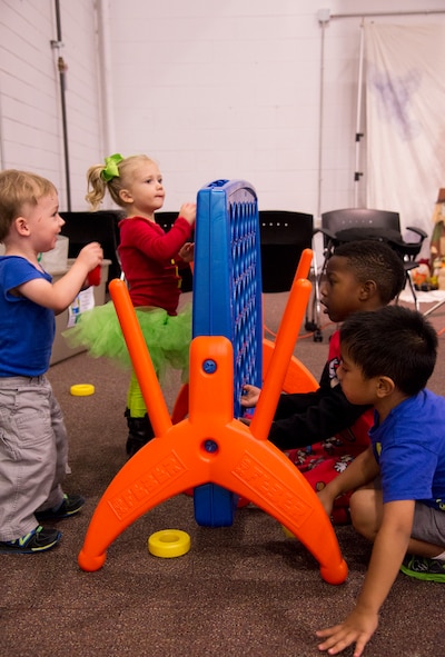 Children play together at the Fall Festival for Deployed Families Oct. 30, 2014, at Moody Air Force Base, Ga. The Airman and Family Readiness Center hosts the annual festival to bring deployed families together and give them an opportunity to enjoy themselves. (U.S. Air Force photo by Senior Airman Sandra Marrero/Released)
