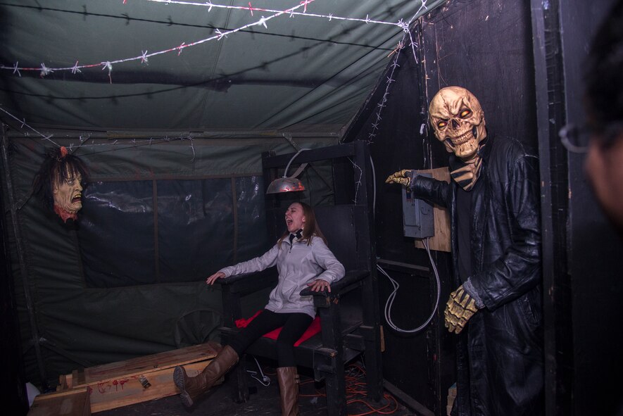 Haunted house volunteers simulate an electrocution during the 34th Annual Moody Air Force Base Haunted House Nov. 1, 2014, in Valdosta, Ga. The haunted house featured a lights-on portion for children and a lights-off portion for brave adults. (U.S. Air Force photo by Senior Airman Sandra Marrero/Released)