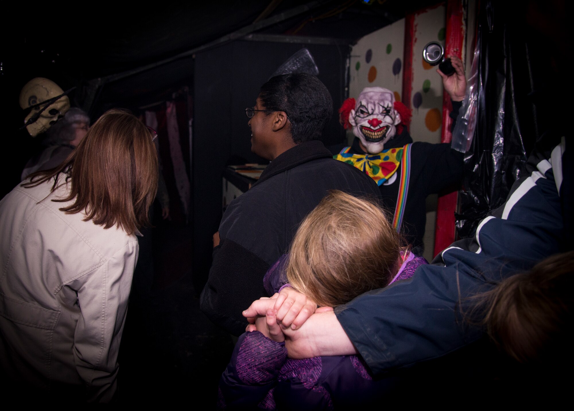 A girl clasps her father’s hand as she goes through the 34th Annual Moody Air Force Base Haunted House Nov. 1, 2014, in Valdosta, Ga. The Civil Engineer Recreational Program hosts and helps build the haunted house each year. (U.S. Air Force photo by Senior Airman Sandra Marrero/Released)
