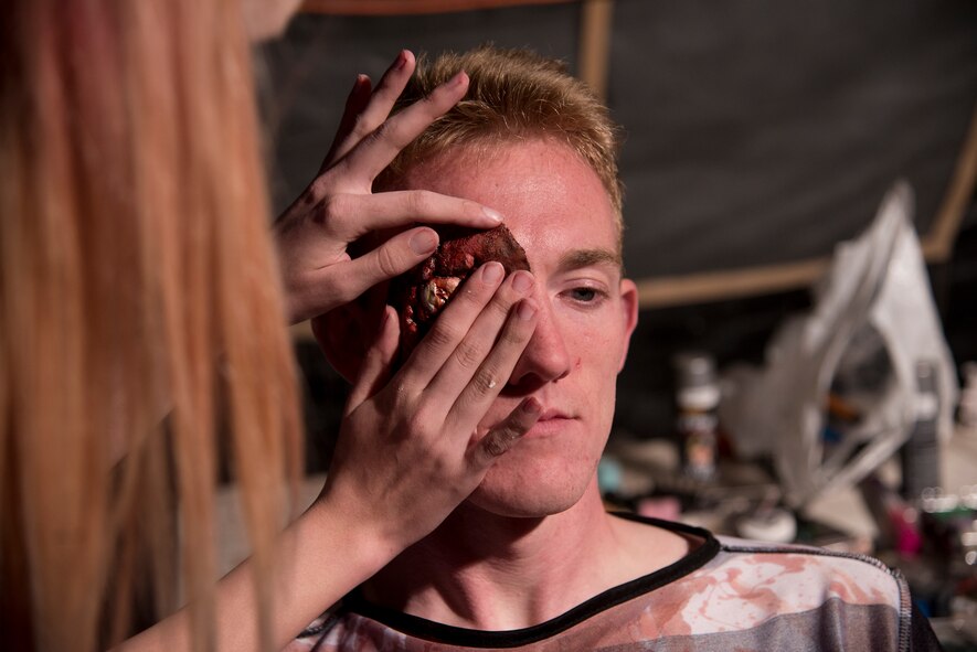 U.S. Air Force Airman 1st Class Kaelob King, 23d Civil Engineer Squadron explosive ordnance disposal apprentice has makeup applied before the 34th Annual Moody Air Force Base Haunted House Nov. 1, 2014, in Valdosta, Ga. King and other volunteers dressed in costume to scare haunted house attendees. (U.S. Air Force photo by Senior Airman Sandra Marrero/Released)
