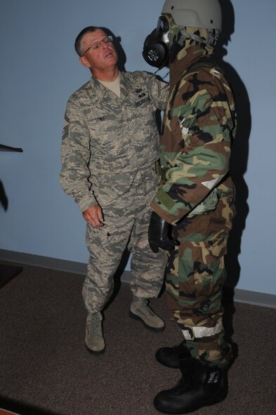 Air Force Reserve Senior Master Sgt. Vern Lewis, Noncommissioned Officer in Charge (NCOIC) of the 910th Airlift Wing’s Inspector General’s Office, checks the Mission Oriented Protective Posture (MOPP) gear of a Citizen Airman during a Chemical, Biological, Radiological, Nuclear and high yield Explosives (CBRNE) exercise during the Unit Training Assembly here, Nov. 2, 2014. The 910th Airlift Wing’s Inspector General’s Office conducted the CBRNE exercise with support from the 910th Civil Engineer Squadron Emergency Management Flight in an effort to give Servicemembers more training with their protective equipment. U.S. Air Force photo/ Tech. Sgt. Rick Lisum. 