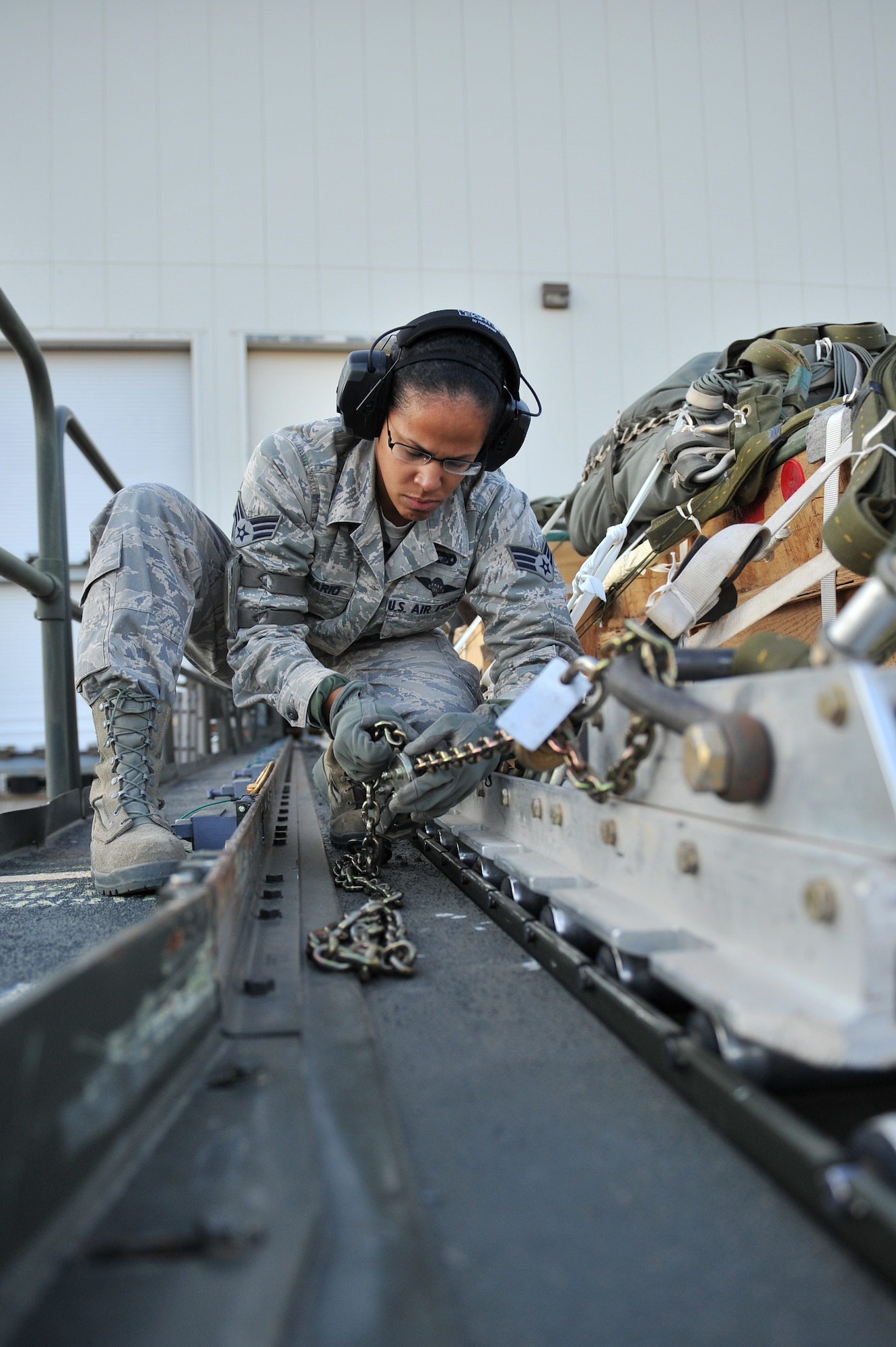 ALTUS AIR FORCE BASE, Okla. – U.S. Air Force Senior Airman Rangeline Rosario, 97th Logistics Readiness Squadron air transportation journeyman, secures a cargo pallet onto a Tunner 60K aircraft cargo loader Oct. 30, 2014. Once the pallet is secured onto the cargo loader, it can be transported to the U.S. Air Force C-17 Globemaster III cargo aircraft for used in an airdrop training mission by the 58th Airlift Squadron. (U.S. Air Force Photo by Senior Airman Dillon Davis/Released)