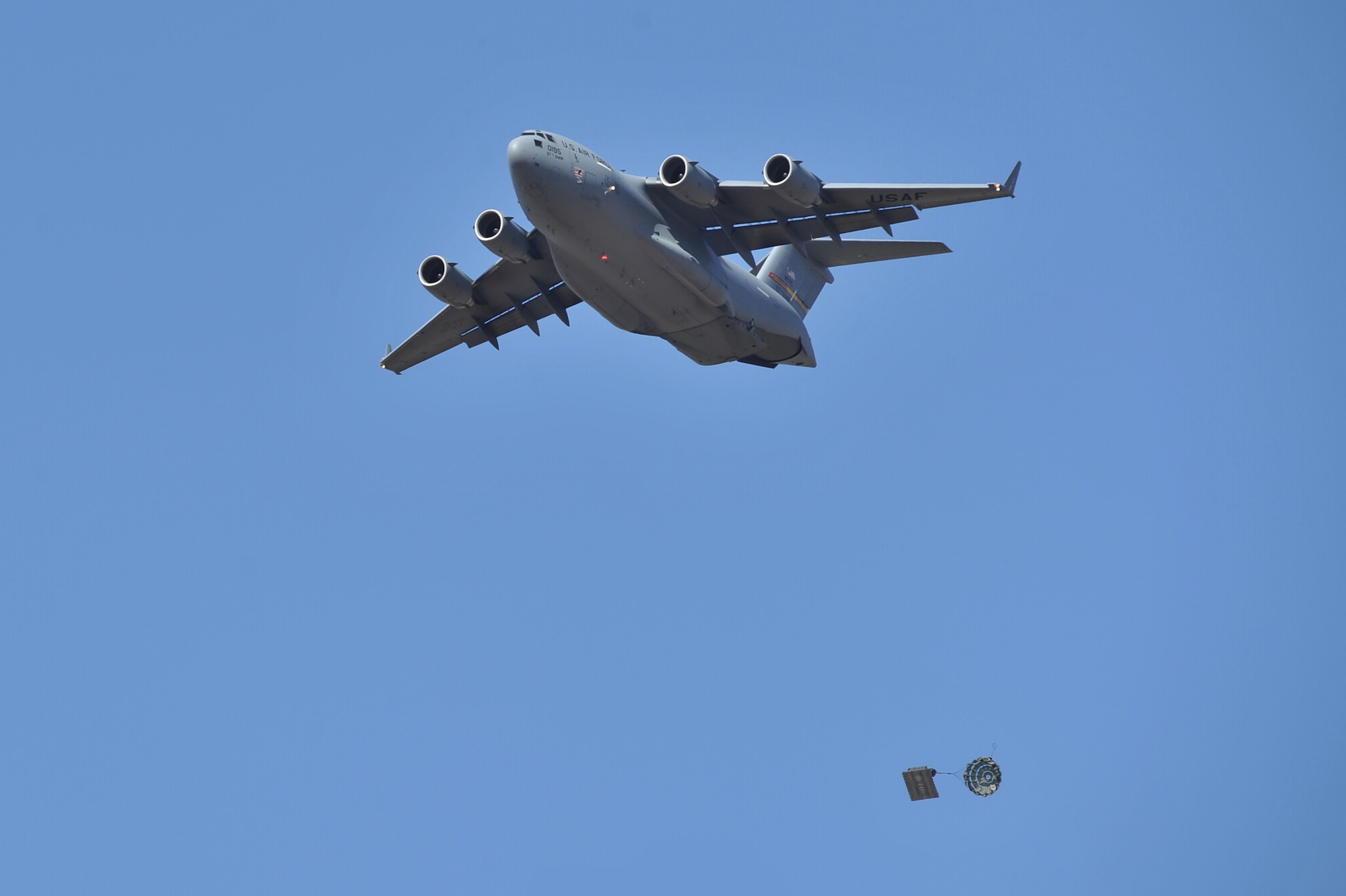HOLLIS, Okla. – A U.S. Air Force C-17 Globemaster III cargo aircraft drops a cargo pallet during an airdrop training mission Oct. 30, 3014. The 58th Airlift Squadron, from Altus Air Force Base, performs airdrop training missions to ensure that the loadmasters-in-training are fully qualified to perform real-world contingency and humanitarian missions worldwide. (U.S. Air Force Photo by Senior Airman Dillon Davis/Released)