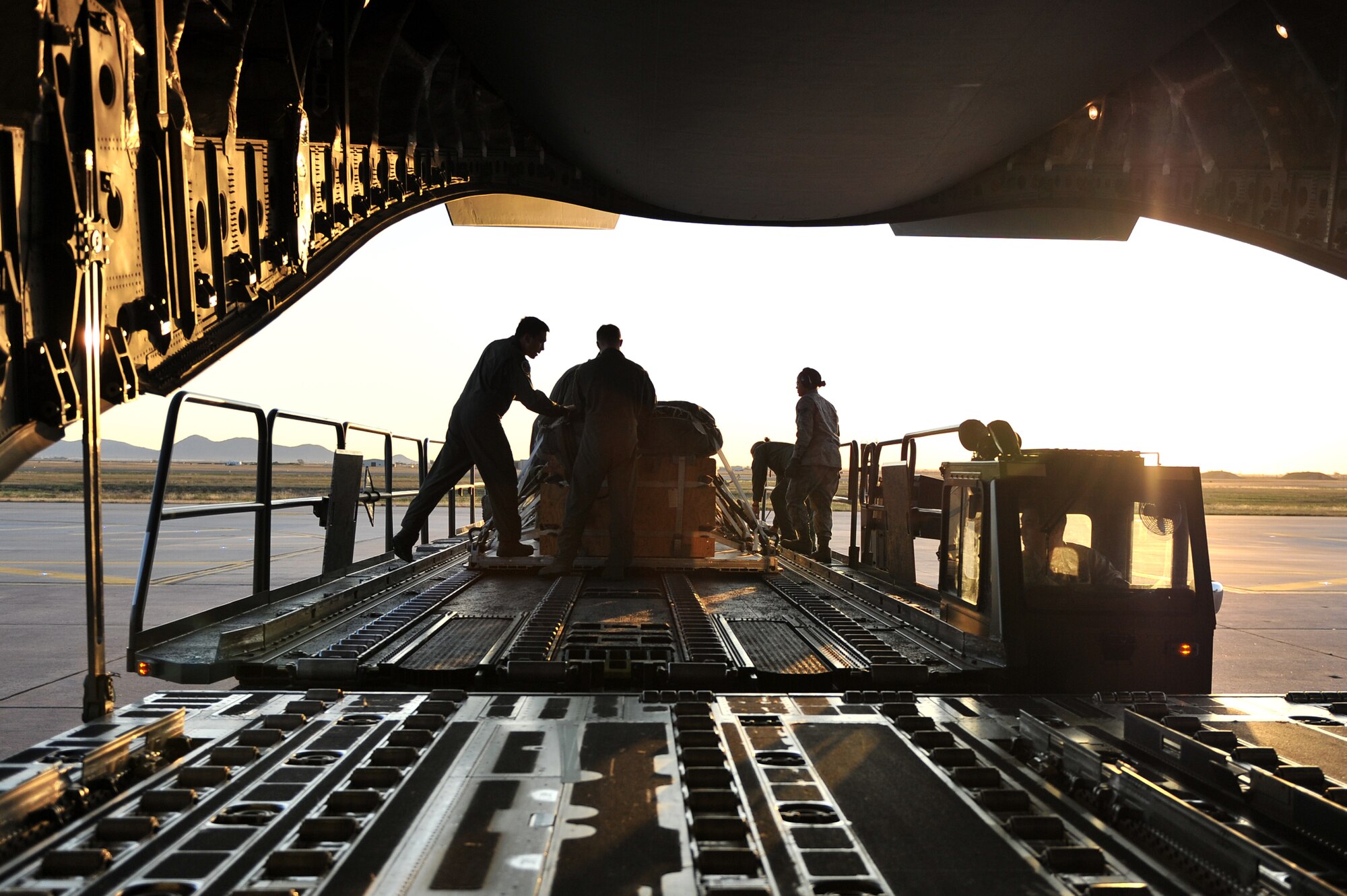 ALTUS AIR FORCE BASE, Okla. – Airmen from the 97th Logistics Readiness Squadron air delivery flight and the 58th Airlift Squadron prepare to load a cargo pallet onto a U.S. Air Force C-17 Globemaster III cargo aircraft for a training mission Oct. 30, 2014. The cargo pallet is made up of lumber and simulates the relative actual weight of supply airdrops used in global contingency and humanitarian operations. (U.S. Air Force Photo by Senior Airman Dillon Davis/Released)