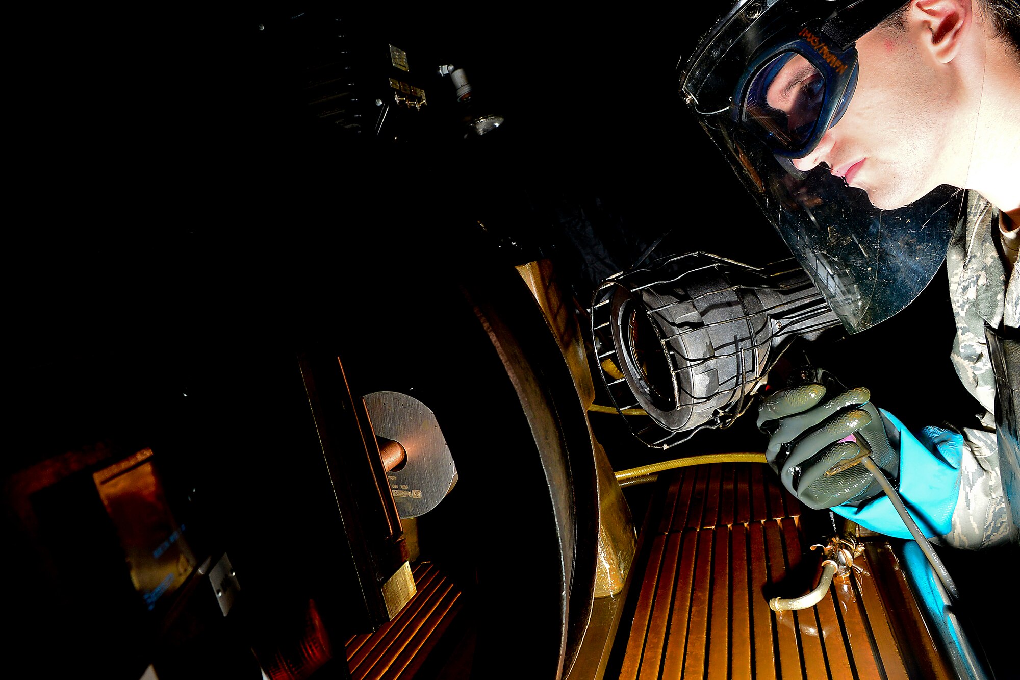 U.S. Air Force Senior Airman Nathan Taylor, 1st Maintenance Squadron nondestructive inspection journeyman, operates a magnetic particle unit at Langley Air Force Base, Va., Nov. 3, 2014. A magnetic particle unit is used for detecting discontinuities in ferromagnetic parts. When magnetic particles are applied to aircraft parts, the poles attract particles and an indication of a discontinuity is formed. (U.S. Air Force photo by Staff Sgt. Antoinette Gibson/Released)