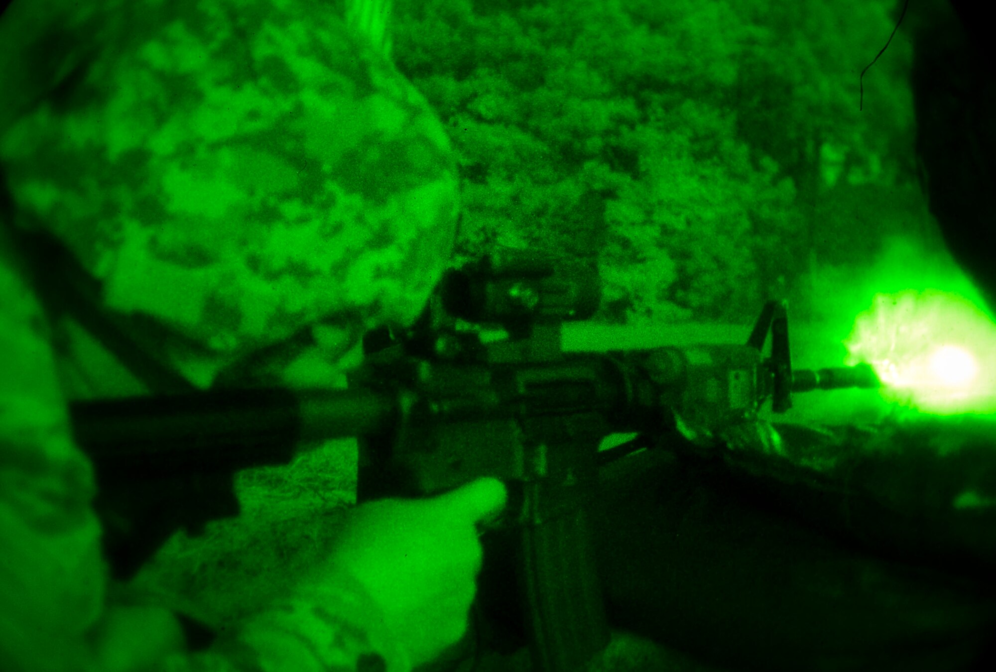 U.S. Air Force Staff Sgt. Charles Duval, 633rd Security Forces Squadron base defense operations center controller, fires an M-4 carbine at a target at Fort Eustis, Va., Oct. 30, 2014.  SFS Airmen performed night fire training as a way to maintain proficiency in firing during low-light situations. (U.S. Air Force photo by Senior Airman Kayla Newman/Released) 