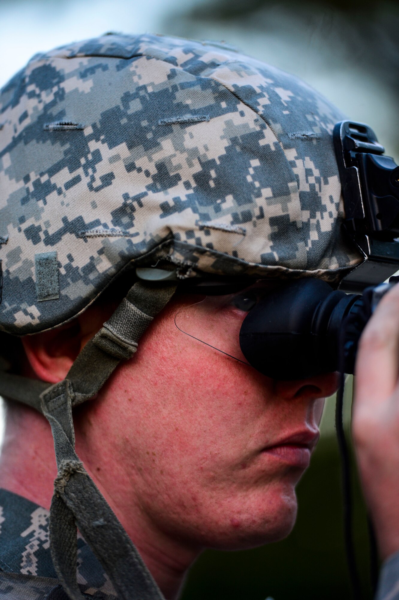 U.S. Air Force Staff Sgt. Charles Duval, 633rd Security Forces Squadron base defense operations center controller, tests night vision goggles prior to night fire marksmanship at Fort Eustis, Va., Oct. 30, 2014.  Along with firing during daylight, 633rd SFS Airmen performed night firing to enhance capabilities in low-light situations. (U.S. Air Force photo by Senior Airman Kayla Newman/Released) 