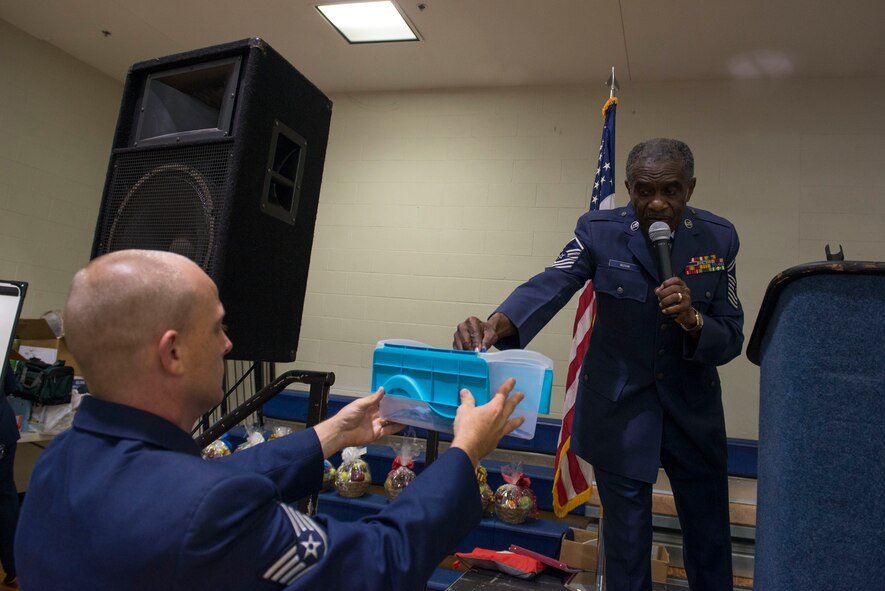 Retired U.S. Air Force Chief Master Sgt. James Ingram, 23d Wing Retiree Activities Office director, draws a door prize ticket during the Retiree Appreciation Day opening ceremony Nov. 1, 2014, at Moody Air Force Base, Ga. During the ceremony, Ingram, who helped organize the week’s events, announced this year’s theme was “Heroes.” (U.S. Air Force photo by Airman 1st Class Dillian Bamman/Released)