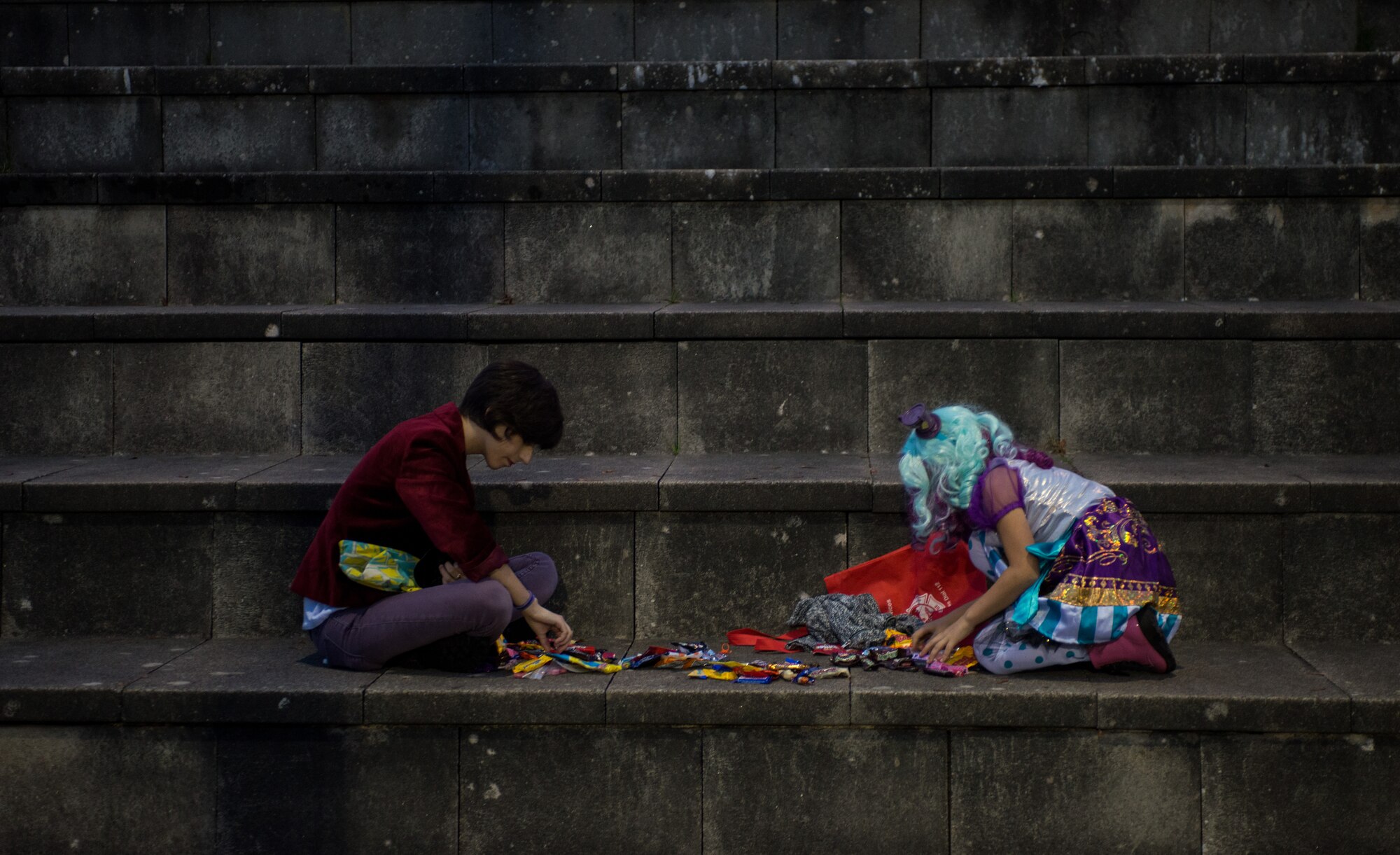 Children count candy after trick-or-treating during Trunk or Treat Oct. 31, 2014, at Ramstein Air Base, Germany. Trick-or-treaters of all ages attended this year’s Trunk or Treat, which included food, movies, games, contests and candy. Courtesy photo (U.S. Air Force photo/Senior Airman Jonathan Stefanko)