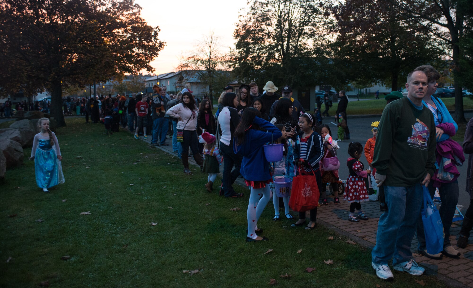 Trick-or-treaters wait in line to receive candy during Trunk or Treat Oct. 31, 2014, at Ramstein Air Base, Germany. Trick-or-treaters of all ages attended this year’s Trunk or Treat, which included food, movies, games, contests and candy. Courtesy photo (U.S. Air Force photo/Senior Airman Jonathan Stefanko)