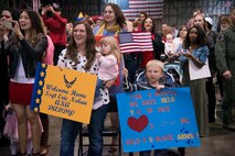 Heidi Nolan and her children, Dakota and Elijah, await the arrival of U.S. Air Force Staff Sgt. Eric Nolan, 13th Aircraft Maintenance Unit avionics technician, during a homecoming ceremony at Misawa Air Base, Japan, Oct. 14, 2014. Base leadership and more than 150 friends and family members were on hand to welcome the 13th Fighter Squadron pilots and AMU maintainers home from a six-month deployment. During the deployment, the units delivered decisive airpower for U.S. Air Forces Central Command operations, coalition nations and the United States. (U.S. Air Force photo by Staff Sgt. Alyssa C. Wallace/Released) 