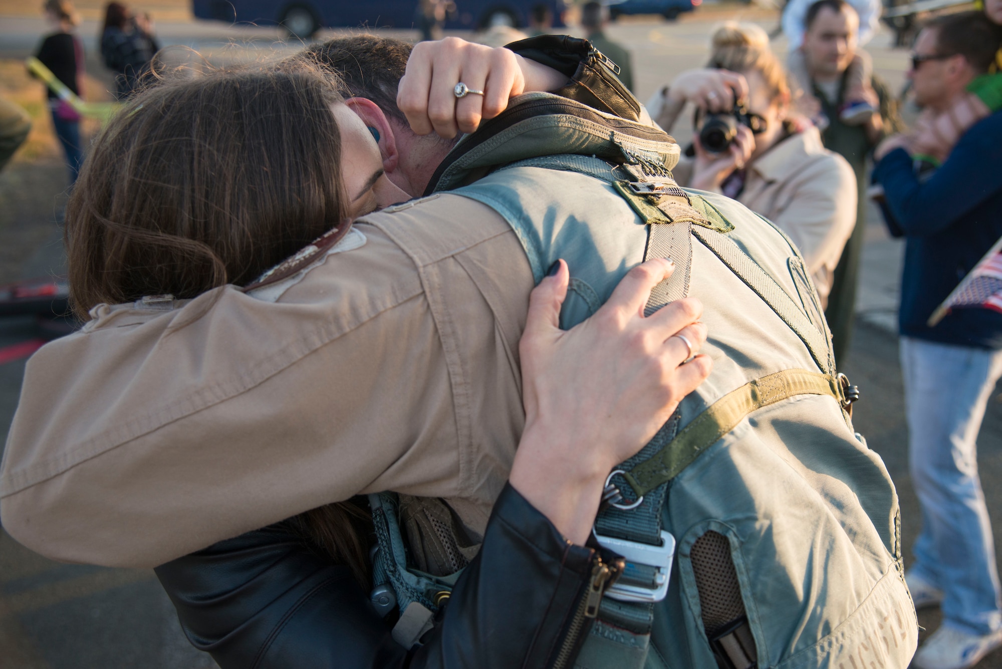 U.S. Air Force Capt. Christopher Hartman, 13th Fighter Squadron F-16 Fighting Falcon pilot, is greeted by his wife upon arrival to Misawa Air Base, Japan, Oct. 25, 2014. More than 50 family members, friends and peers gathered on the flightline to welcome Hartman and other 13 FS pilots home after being deployed more than six months. During the deployment, members of the 13 FS continuously collaborated across the U.S. Central Command area of responsibility. (U.S. Air Force photo by Staff Sgt. Alyssa C. Wallace/Released) 