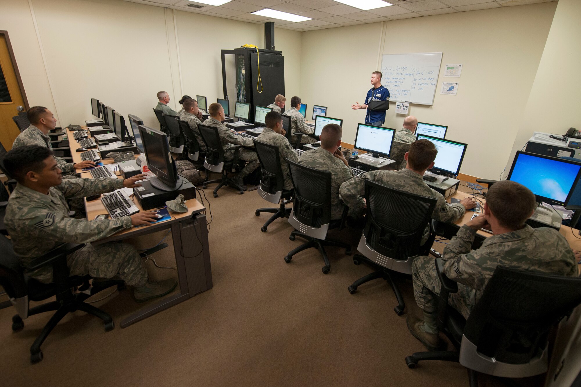 Senior Airman Tyler Trusty, 8th Comptroller Squadron financial services technician, explains the process of filing a travel voucher at Kunsan Air Base, Republic of Korea, Nov. 1, 2014. CPTS personnel provided mass financial briefings for approximately 400 Airmen returning from Osan Air Base, ROK, and Eielson Air Force Base, Ala., after completing DISTANT FRONTIER and RED FLAG-Alaska exercises during Kunsan’s runway closure. (U.S. Air Force photo by Senior Airman Katrina Heikkinen/Released)