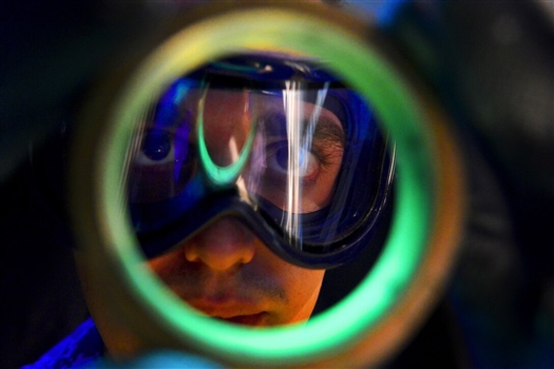 Air Force Airman 1st Class Michael Griffin inspects an aircraft part on Langley Air Force Base, Va., Nov. 3, 2014. Griffin is an inspection technician assigned to the 1st Maintenance Squadron, where numerous techniques – including x-ray systems -- are used to help prevent aircraft damage or personnel injury.