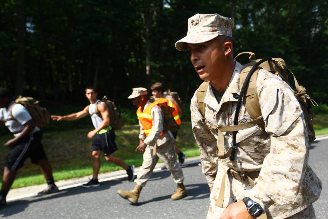 Gunnery Sgt. Nelson Roman, the supply chief for Marine Corps Recruiting Station New Jersey, belts some Marine Corps cadence for the Cedar Creek High School football team during a leadership seminar aboard Naval Weapons Station Earle in Colts Neck, N.J., Aug. 1, 2014. 