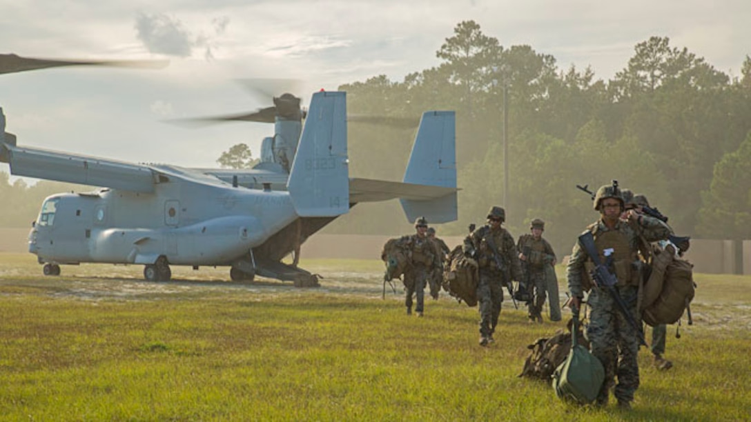 Marines with Echo Company, 2nd Battalion, 8th Marine Regiment, 2nd Marine Division unload from an MV-22B Osprey at a Military Operations on Urban Terrain town aboard Marine Corps Base Camp Lejeune, N.C., Oct. 30, 2014. The Marines were flown to the MOUT town to conduct an embassy reinforcement operation in conjunction with Exercise Bold Alligator 2014. Bold Alligator is a scenario-driven, simulation-supported, amphibious assault exercise and is the largest exercise held on the East Coast. The exercise is scheduled to be conducted through Nov. 10. The battalion is participating in the exercise to prepare for the unit’s upcoming deployment as the ground combat element for the Black Sea Rotational Force.