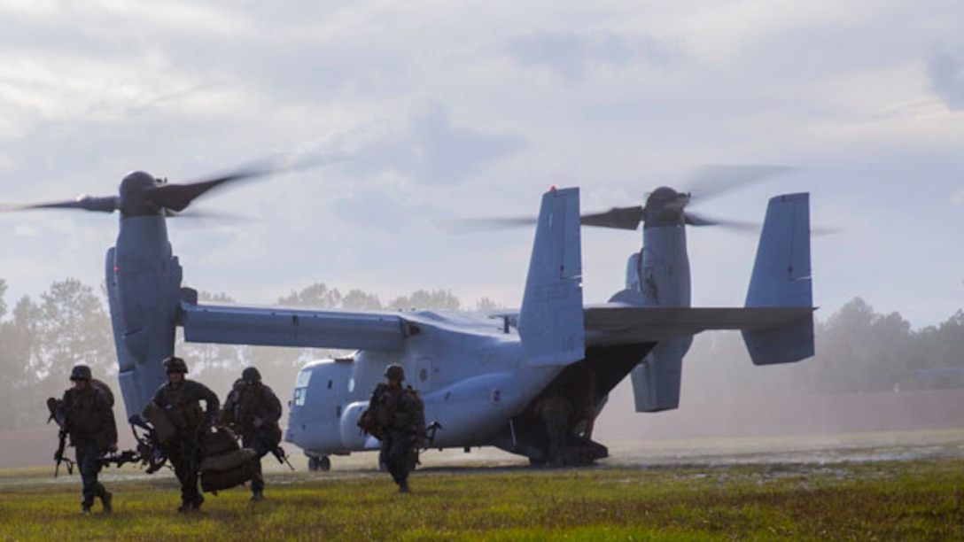 Marines with Echo Company, 2nd Battalion, 8th Marine Regiment, 2nd Marine Division unload from an MV-22B Osprey at a Military Operations on Urban Terrain town aboard Marine Corps Base Camp Lejeune, N.C., Oct. 30, 2014. The Marines were flown to the MOUT town to conduct an embassy reinforcement operation in conjunction with Exercise Bold Alligator 2014. Bold Alligator is a scenario-driven, simulation-supported, amphibious assault exercise and is the largest exercise held on the East Coast. The exercise is scheduled to be conducted through Nov. 10. The battalion is participating in the exercise to prepare for the unit’s upcoming deployment as the ground combat element for the Black Sea Rotational Force.