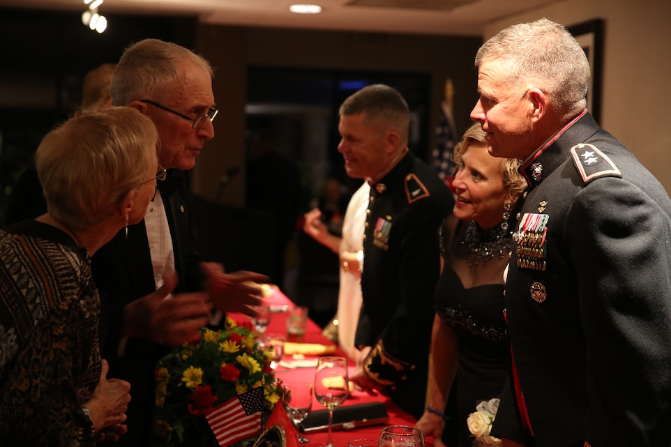 Retired Col. Owen Gillick and his wife Audrey Gillick talk to Maj. Gen. Lewis A. Craparotta, Combat Center Commanding General, and his wife Laurie Craparotta about what they enjoyed at the ceremony during the 10th Annual Marine Corps retiree ball at the Mameluke Officers’ Club, Nov. 1, 2014.