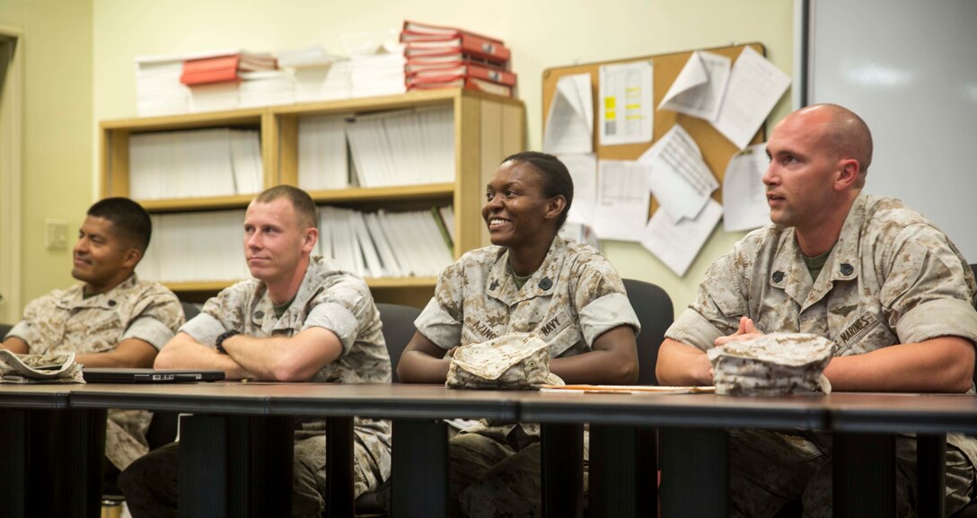 Students from the career course listen as a guest speaker talks about effective leadership Oct. 1 at the Staff Noncommissioned Officer Academy on Camp Hansen. As one of the students in attendance, Petty Officer 1st Class Xiomara A. Azinge challenges herself as a sailor to learn more about the Marine Corps side of her job to better assist the Marines she serves. Azinge is from Bronx, New York, and a surgical technician with 3rd Medical Battalion, 3rd Marine Logistics Group, III Marine Expeditionary Force. 