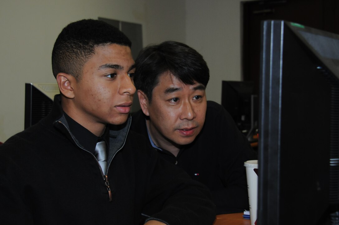 Sin Choe, district mechanical engineer, explains to Seoul American High School senior Warren Nieto how the process of design analysis works.