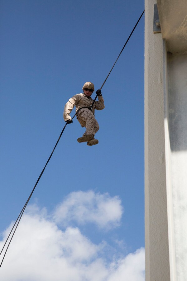 Cpl. Austin J. Fowler rappels down the Camp Schwab rappel tower Oct. 23 during an insertion techniques training event. The training was part of a monthlong 5th Air Naval Gunfire Liaison Company Basic Course. Each Marine was required to rappel off the tower twice and then fast-rope twice. Fowler is a field radio operator with 5th ANGLICO, III Marine Expeditionary Force Headquarters Group, III MEF. (U.S. Marine Corps photo by Lance Cpl. Ryan C. Mains/Released)