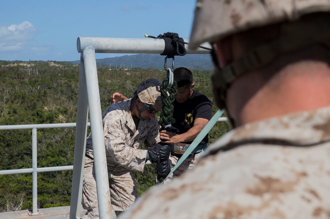 Marines execute rappelling and fast-roping techniques Oct. 23 as a part of the 5th Air Naval Gunfire Liaison Company Basic Course at the Camp Schwab rappel tower. The Marines started the training by rappelling down the tower twice. To end the training, each Marine fast-roped down the tower twice. The Marines are with 5th ANGLICO, III Marine Expeditionary Force Headquarters Group, III MEF. (U.S. Marine Corps photo by Lance Cpl. Ryan C. Mains/Released)
