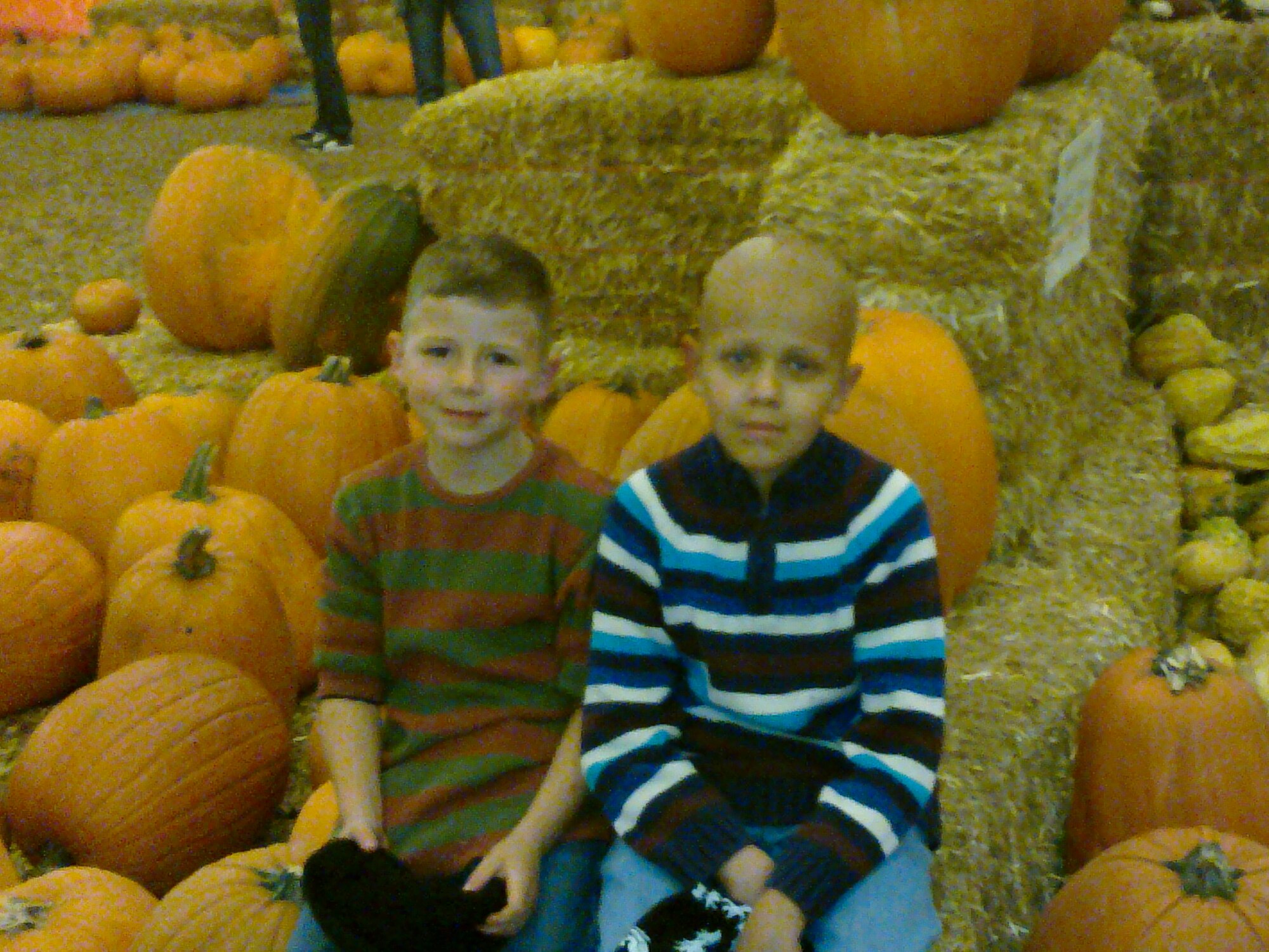 Baily Cooper, left, and Dillon Cooper, sons of Senior Master Sgt. Jason Cooper, 5th Reconnaissance Squadron aircraft maintenance squadron superintendent, pose for a picture as the Cooper family looks for pumpkins to buy in Oct. 2009 in Las Vegas, Nev. Dillon was diagnosed with having a high-grade Medulloblastoma. It is a highly malignant brain tumor (cancer) that originates in the part of the brain towards the back and bottom in the cerebellum. (Courtesy photo)