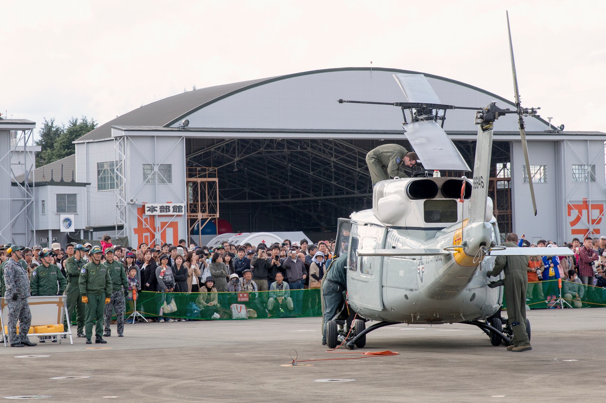 U.S. Air Force members from the 459th Airlift Squadron perform preflight checks in front of attendees during the annual air show at Iruma Air Base, Japan, Nov. 3, 2014. More than 290,000 people of all ages attended the event. (U.S. Air Force photo by Osakabe Yasuo/Released) 