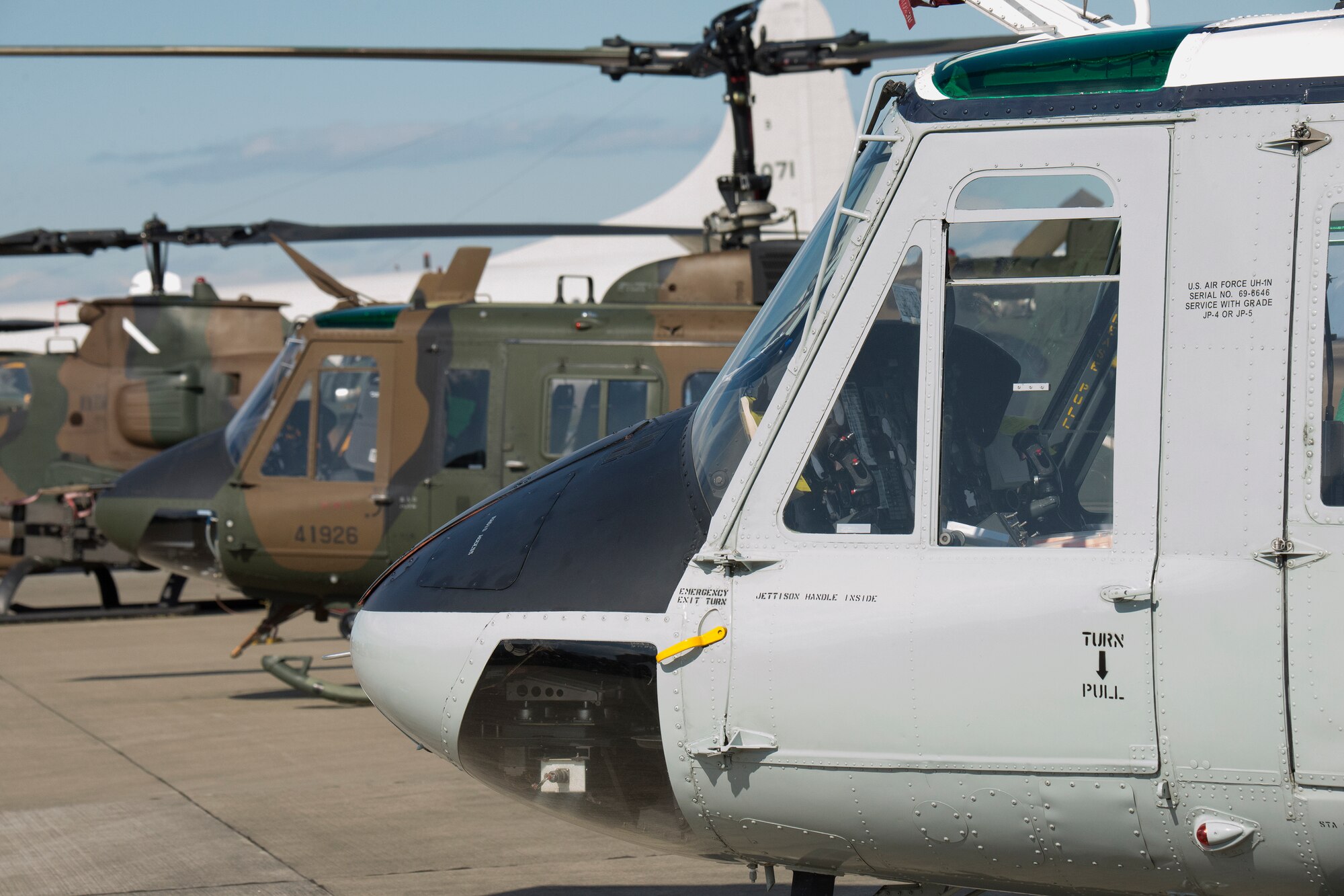 A Yokota UH-1N Huey sits next to its Japanese counterpart during an annual air show at Iruma Air Base, Japan, Nov. 3, 2014. The 459th Airlift Squadron featured the Huey and C-12 Huron at the air show, making it the first U.S. aircraft to be a part of the event. (U.S. Air Force photo by Osakabe Yasuo/Released)
