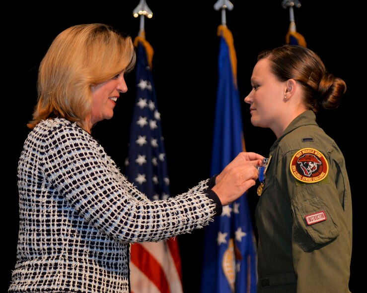 Secretary of the Air Force Deborah Lee James presents the very first Nuclear Deterrence Operations Service Medal to 1st Lt. Victoria Fort, a missile combat crew instructor from the 91st Missile Wing at Minot Air Force Base, N.D., during Air Force Global Strike Command’s 2014 Global Strike Challenge, Nov. 5.  This milestone recognizes the importance and unique demands of the nuclear deterrence mission and the dedication of the Airmen who perform it. (U.S. Air Force photo/Senior Airman Benjamin Gonsier)