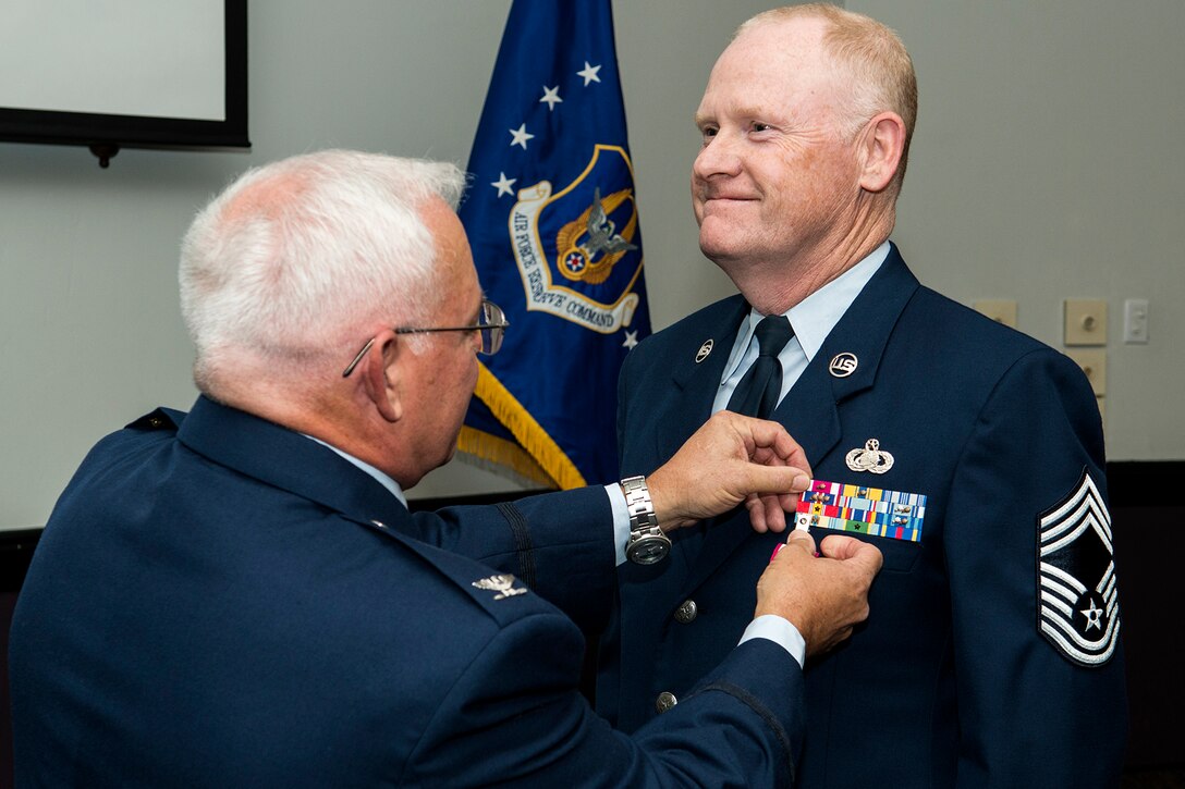 U.S. Air Force Chief Master Sgt. Douglas McClain is awarded the Air Force Meritorious Service Medal during his retirement ceremony, Nov. 1, 2014, Barksdale Air Force Base, La. McClain distinguished himself in the performance of outstanding service to the United States while assigned to the 307th Force Support Squadron, 307th Mission Support Group, 307th Bomb Wing, at Barksdale. (U.S. Air Force photo by Master Sgt. Greg Steele/Released)