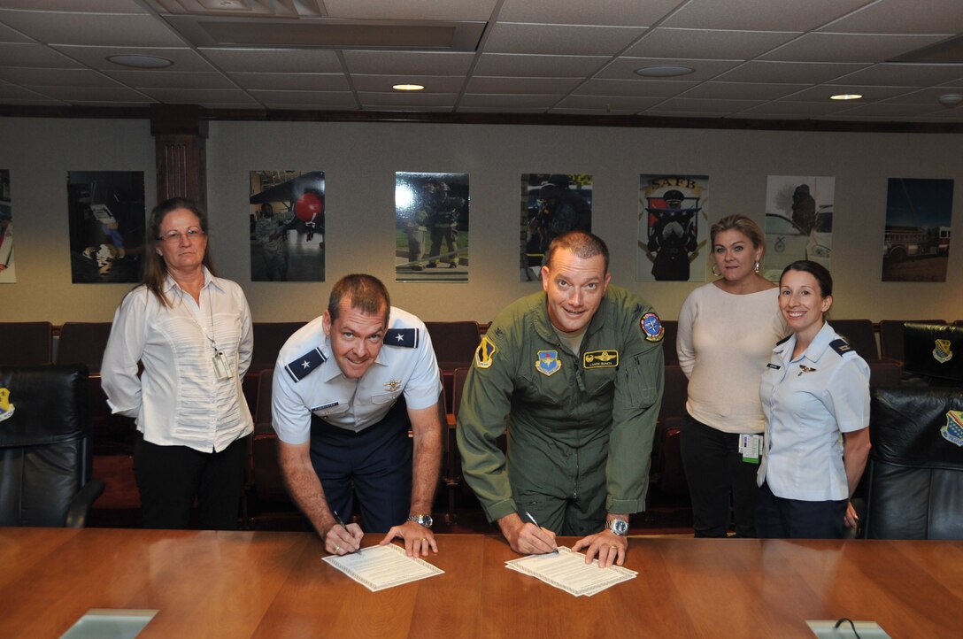 Brig. Gen. Scott Kindsvater, 82nd Training Wing commander, and Col. Lance Bunch, 80th Flying Training Wing commander, support Domestic Violence Awareness Month by signing a proclamation Oct. 28, 2014. Throughout the month, Family Advocacy and several other agencies will be hosting events to remind Team Sheppard of the resources available to them to help prevent and stop domestic violence. (U.S. Air Force photo/Airman 1st Class Robert L. McIlrath)

