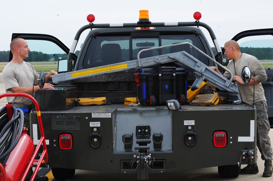 U.S. Air Force Staff Sgts. Bradley Pippin and Peter Chang, 20th Aircraft Maintenance Squadron tactical aircraft maintainers, put a ladder in the back of a truck after hot pit refueling at Shaw Air Force Base, S.C., Nov. 5, 2014. Hot pit refueling is a technique usually performed in a combat situation to rapidly refuel aircraft while their engines remain running. (U.S. Air Force photo by Airman 1st Class Michael Cossaboom/Released) 