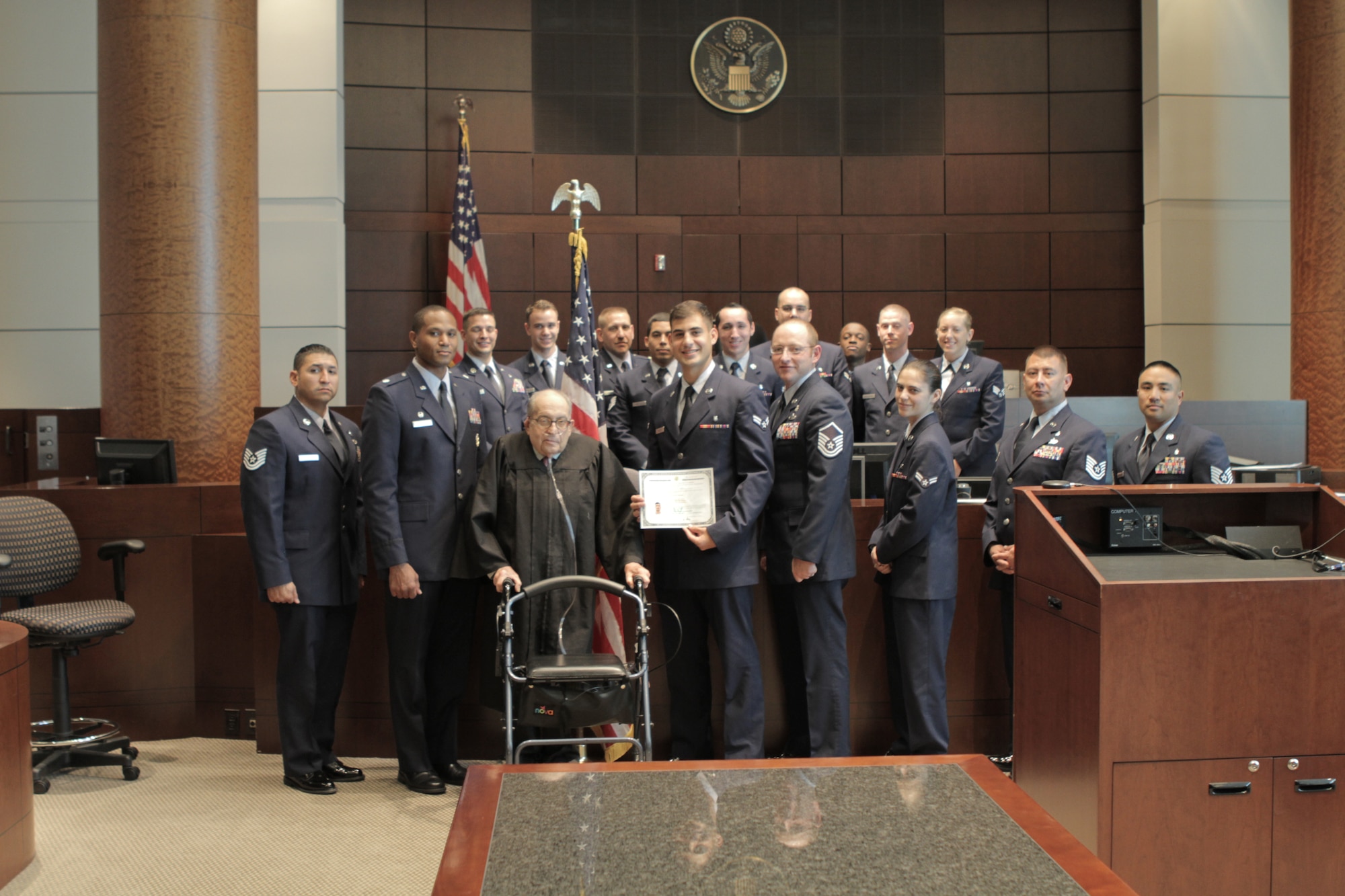 Airman 1st Class Theo Shakir, 375th Medical Support Squadron biomedical equipment receives his citizenship during a ceremony at the Scott Air Force Base Clinic October 29, 2014. Shakir, originally from Iraq, started his process of becoming a citizen of the U.S. three years ago when he joined the military, despite some difficulties, he obtained his citizenship on Oct. 17, 2014 in a ceremony here. ( U.S. Air Force courtesy photo)
