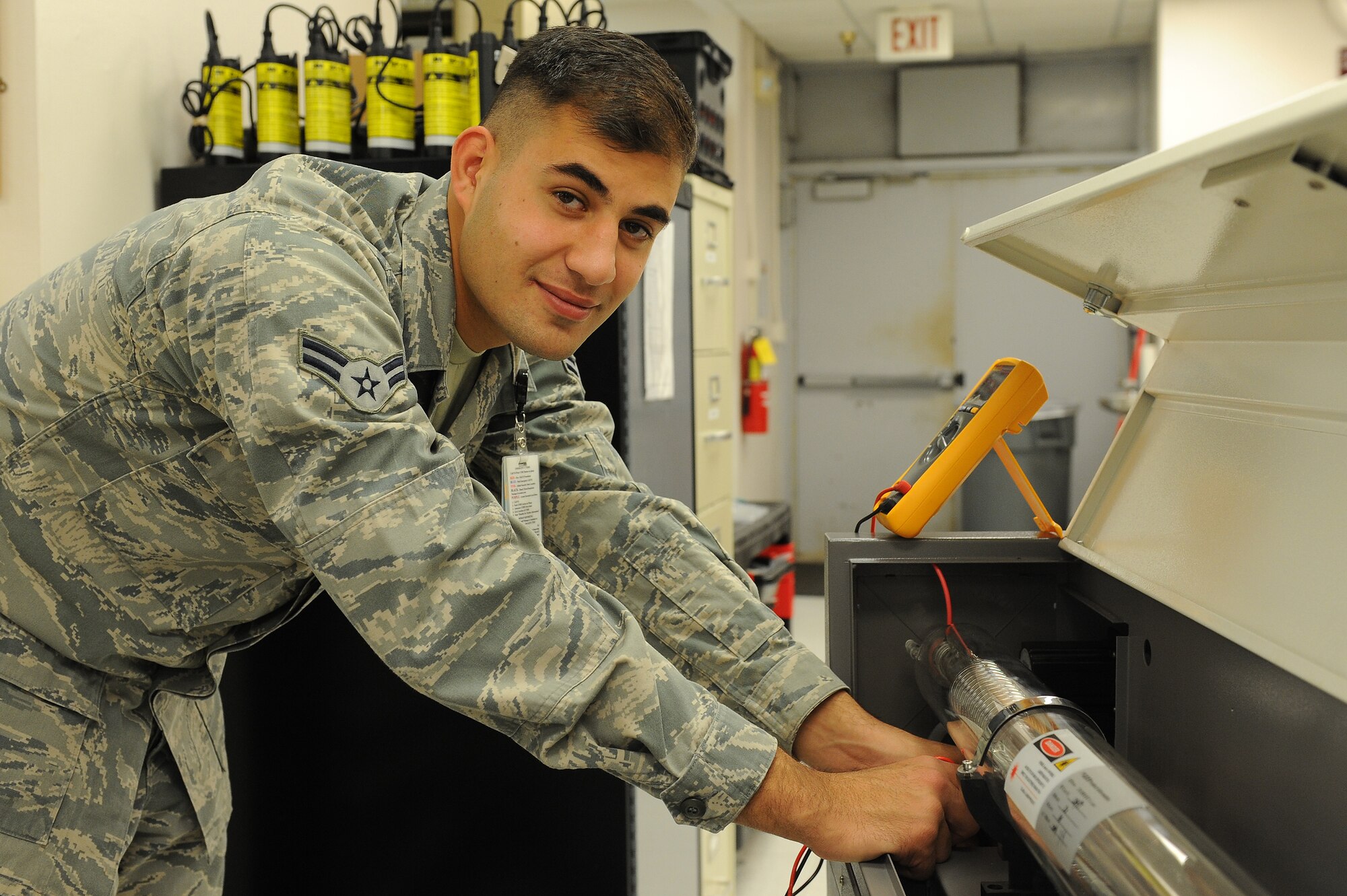 Airman 1st Class Theo Shakir, 375th Medical Support Squadron biomedical equipment technician, fixes a broken piece of medical equipment in the Scott Clinic October 29, 2014. Shakir, originally from Iraq, started his process of becoming a citizen of the U.S. three years ago when he joined the military, despite some difficulties, he obtained his citizenship on Oct. 17, 2014 in a ceremony here. ( U.S. Air Force photo/Senior Airman Sarah Hall-Kirchner)