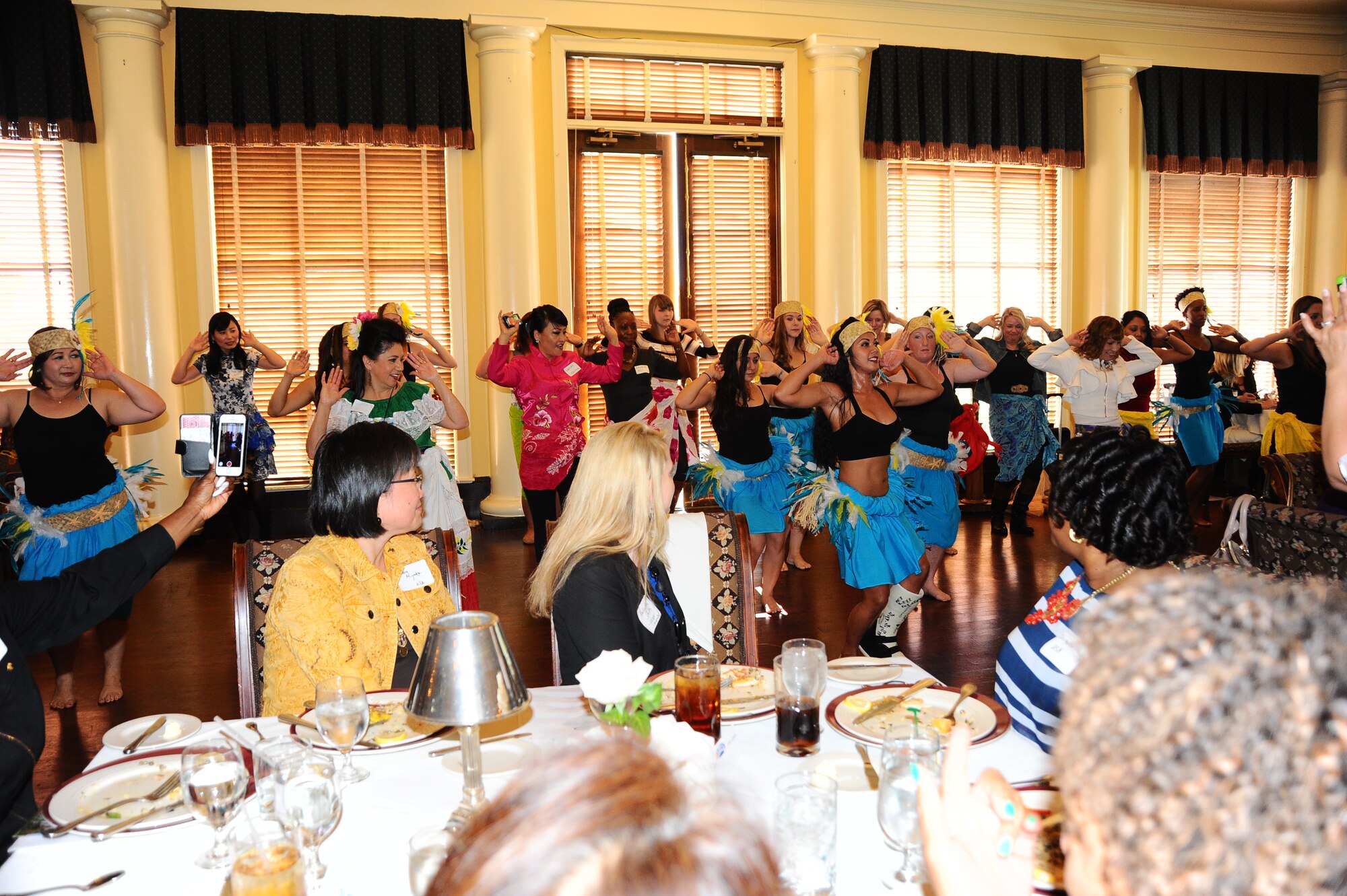 Participants of the 2014 International Spouses’ Appreciation Luncheon receive a short hula lesson from members of the Hot Hula Polynesian dance class offered at the Columbus Air Force Base Fitness Center during the luncheon Oct. 30 at Old Waverly Clubhouse in West Point, Mississippi. More than 80 local community members and Columbus Air Force Base spouses and Airmen gathered at the lunch to make new friends and hear about community information and education opportunities.(U.S. Air Force photo/Tech. Sgt. Amanda Savannah)
