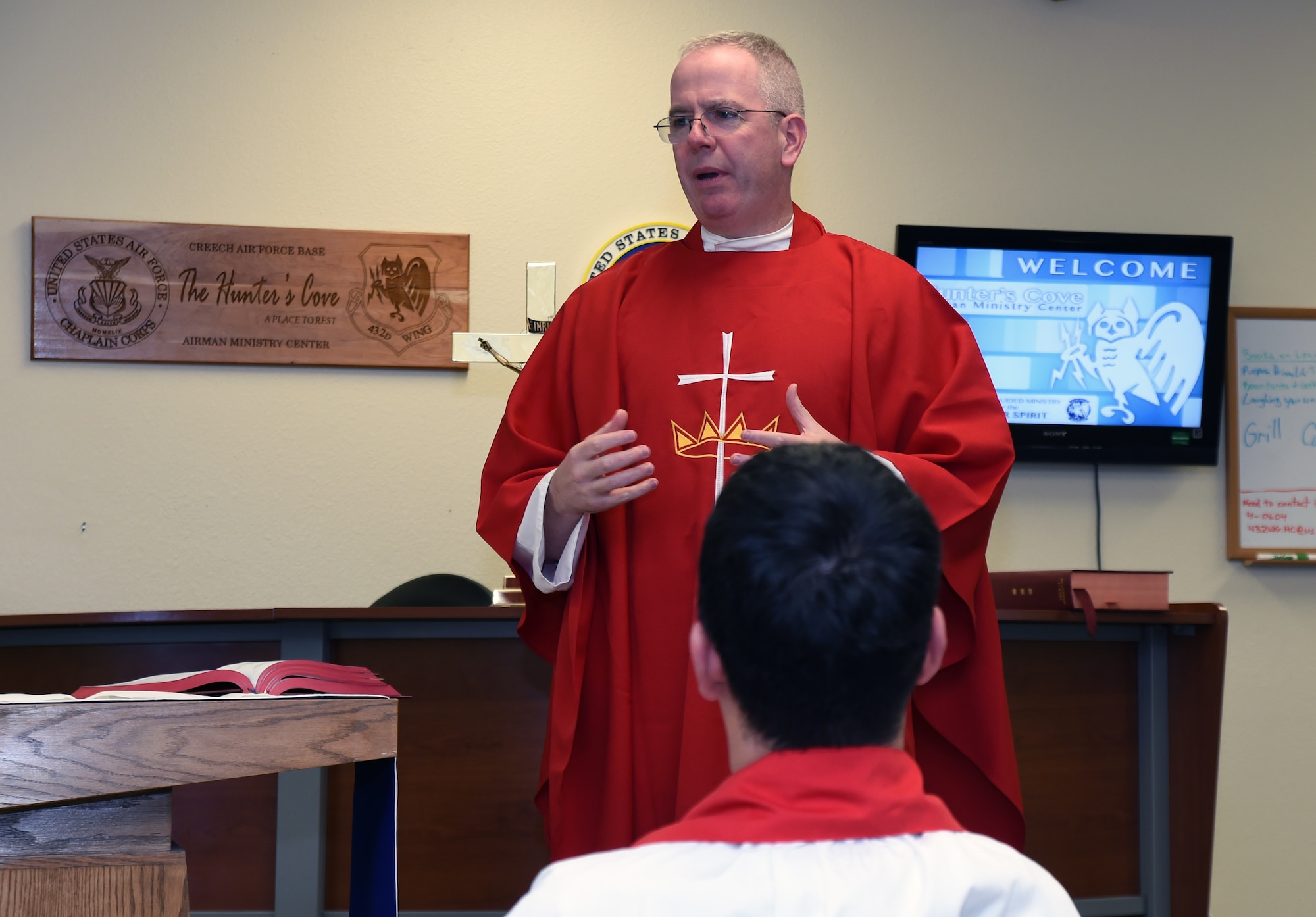 Chaplain (Maj.) James Hamel talks about supporting faith in the military during Mass as part of the “Come Be With Us” chaplain recruiting tour at Creech Air Force Base, Oct. 28, 2014. The tour brings active duty chaplains and civilian priests to Nellis and Creech Air Force Bases to help recruit new chaplains and provides them the opportunity to see different environments in which they might work in. (U.S. Air Force photo by Tech. Sgt. Shad Eidson/Released)