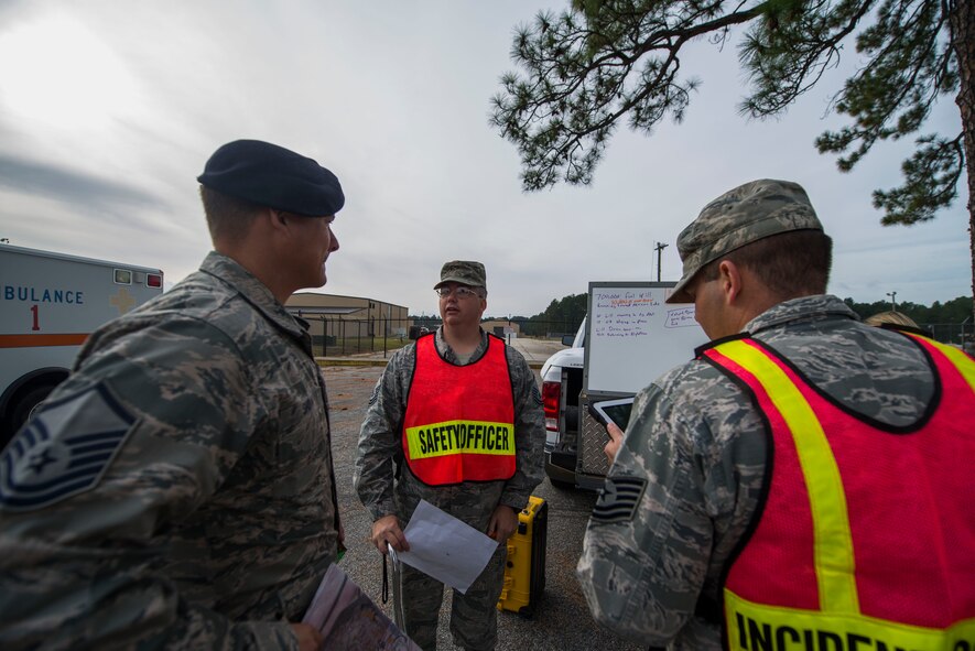 U.S. Air Force Master Sgt. Bradley Shova, 23d Security Forces Squadron incident responder, left, Master Sgt. Michael Howell, middle, 23d Civil Engineer Squadron exercise safety officer, and Tech. Sgt. Jeremy Miller, 23d CES incident commander, stand by during a fuel containment exercise Nov. 5, 2014, at Moody Air Force Base, Ga. The 23d Civil Engineer Squadron conducted the exercise to prepare for possible fuel emergencies. (U.S. Air Force photo by Airman 1st Class Dillian Bamman/Released)