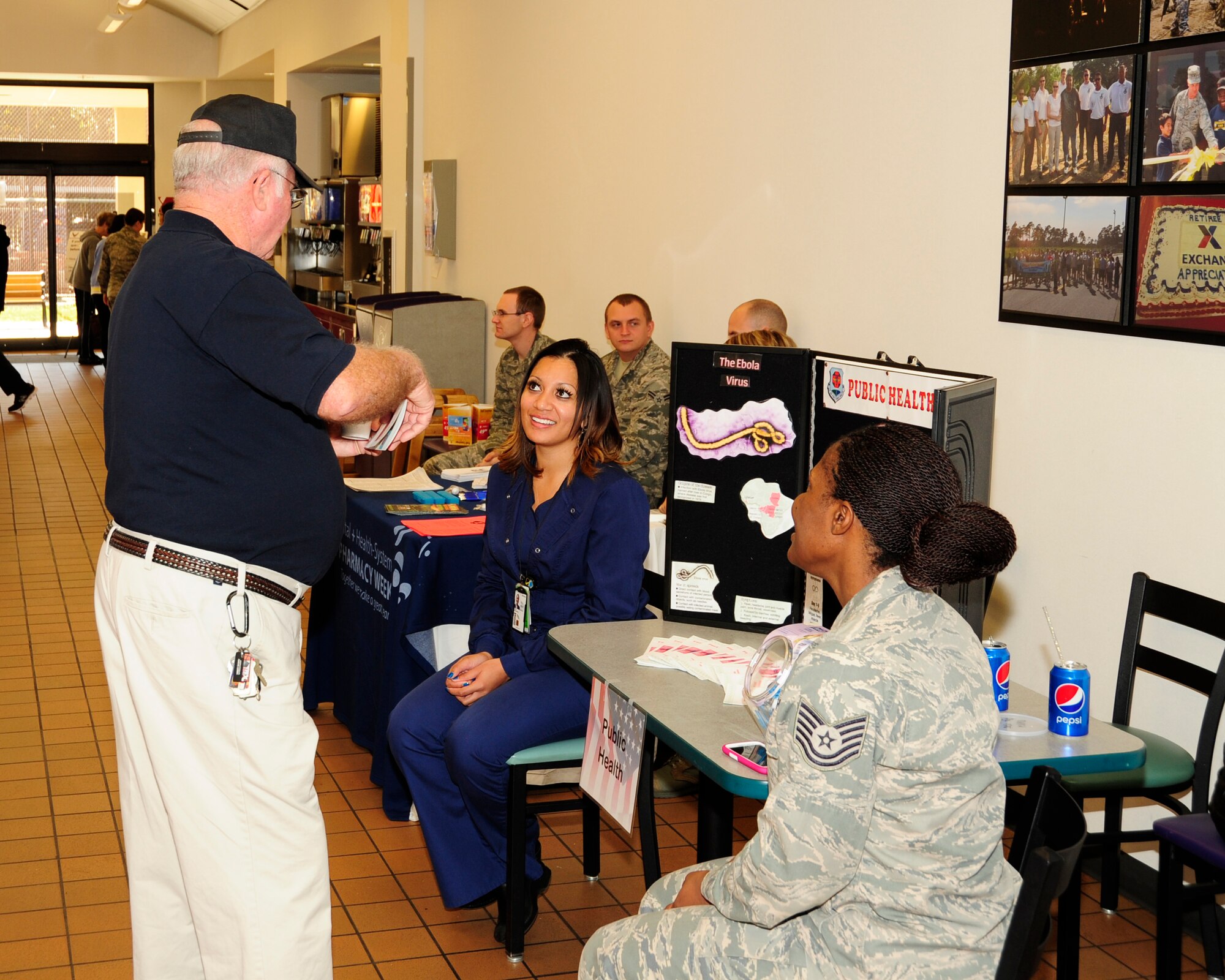 Tyndall 325th Medical Group volunteers brief a retiree Nov. 1 with information about Ebola at the Base Exchange. The Ebola information station was available to retirees for Retiree Appreciation Day. (U.S. Air Force photo by Airman 1st Class Solomon Cook)